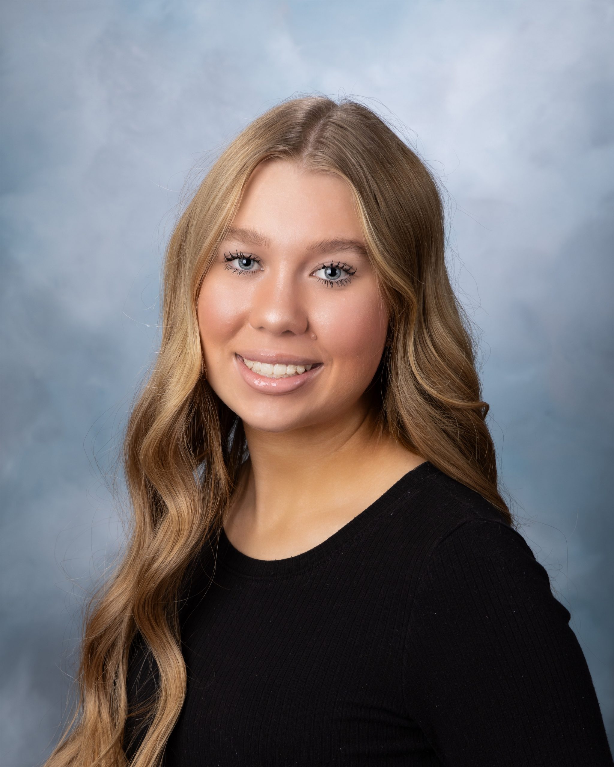 Allen Park High School senior headshot featuring Kayla in black top against blue gradient backdrop