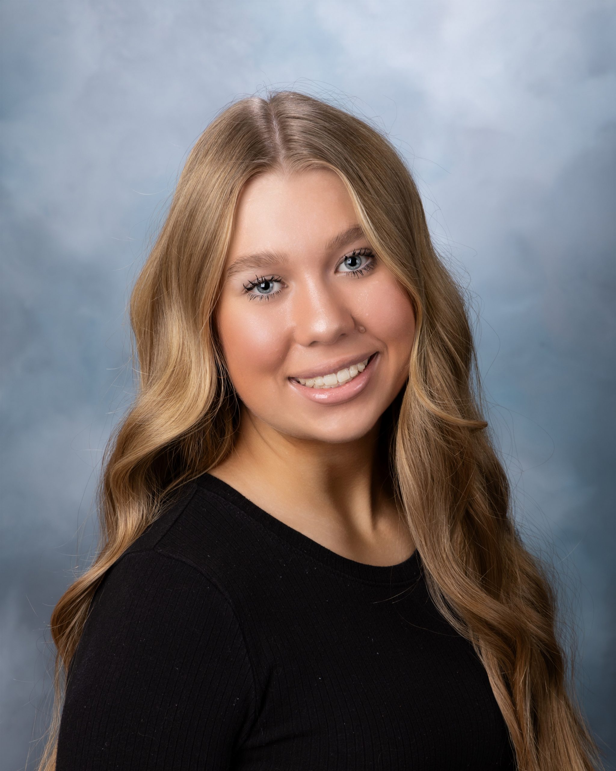 Kayla's professional senior portrait with long blonde hair and black top in Downriver photography studio setting