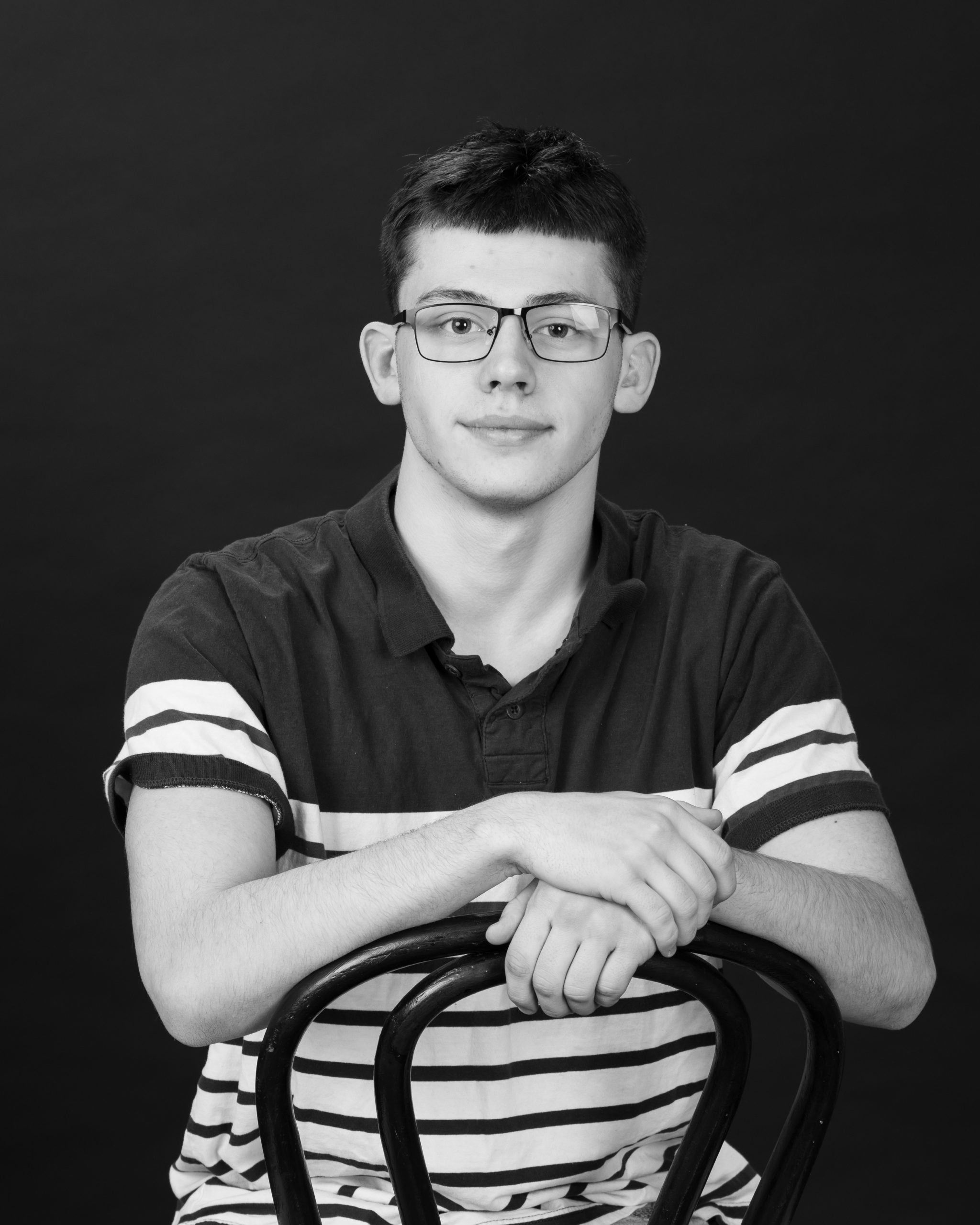 senior student posing with question mark prop during studio session