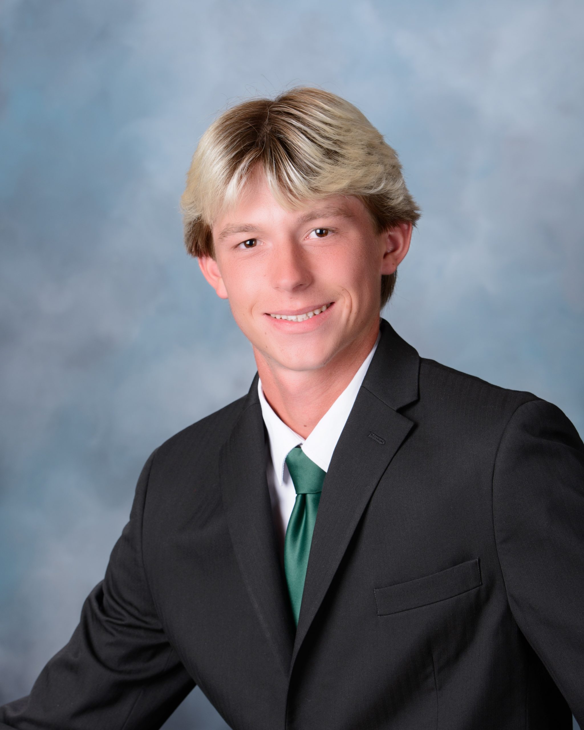 Senior portrait of Luke in formal suit for Allen Park 2025 graduation photos