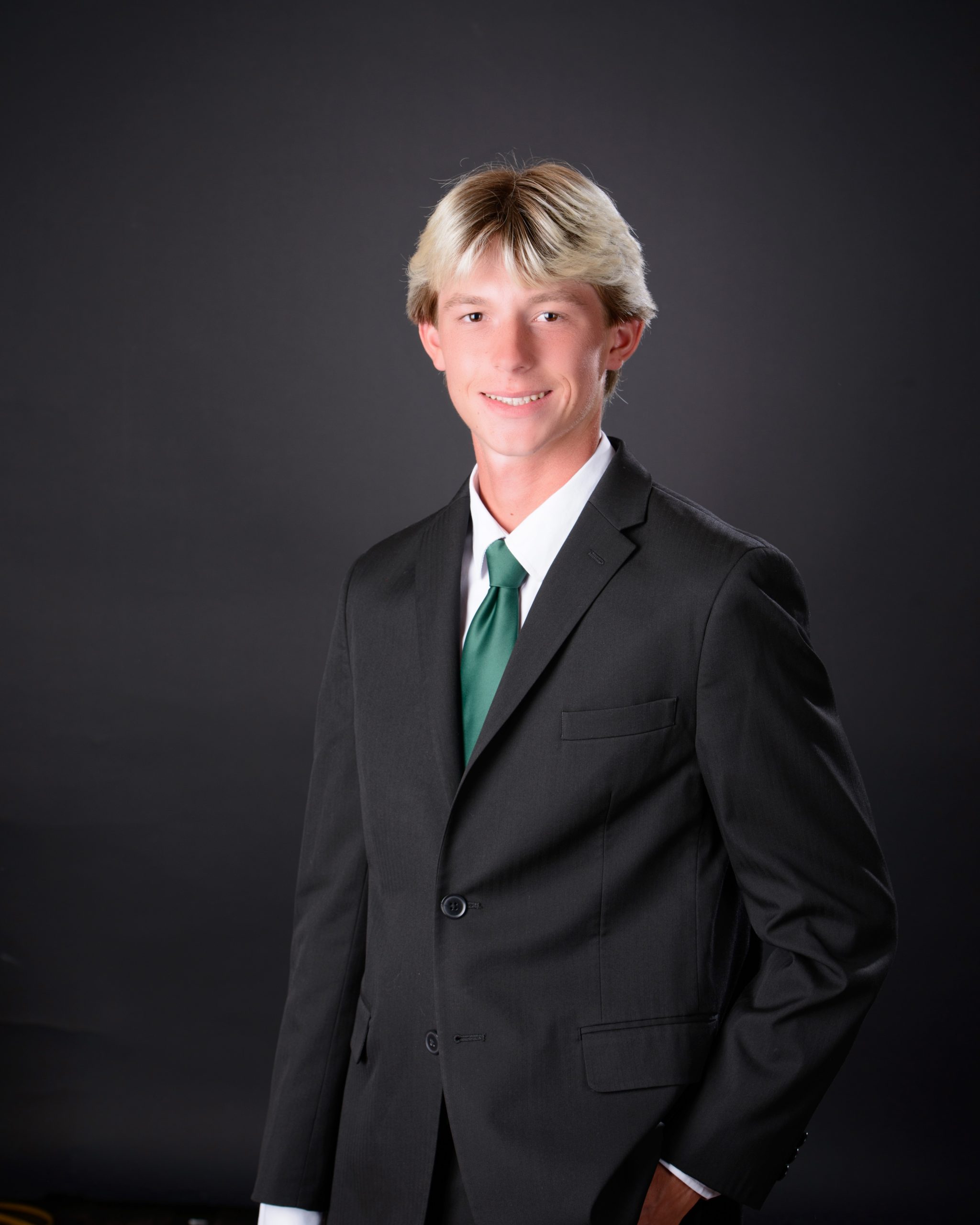 Luke holding '2025' cutout during Allen Park senior photo session at Studio ONE Wyandotte