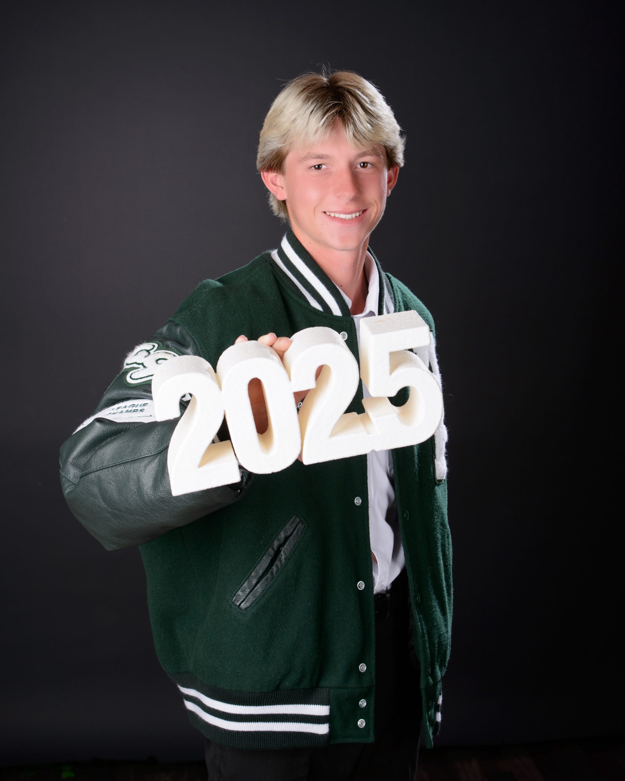 Luke holding '2025' cutout during Allen Park senior photo session at Studio ONE Wyandotte