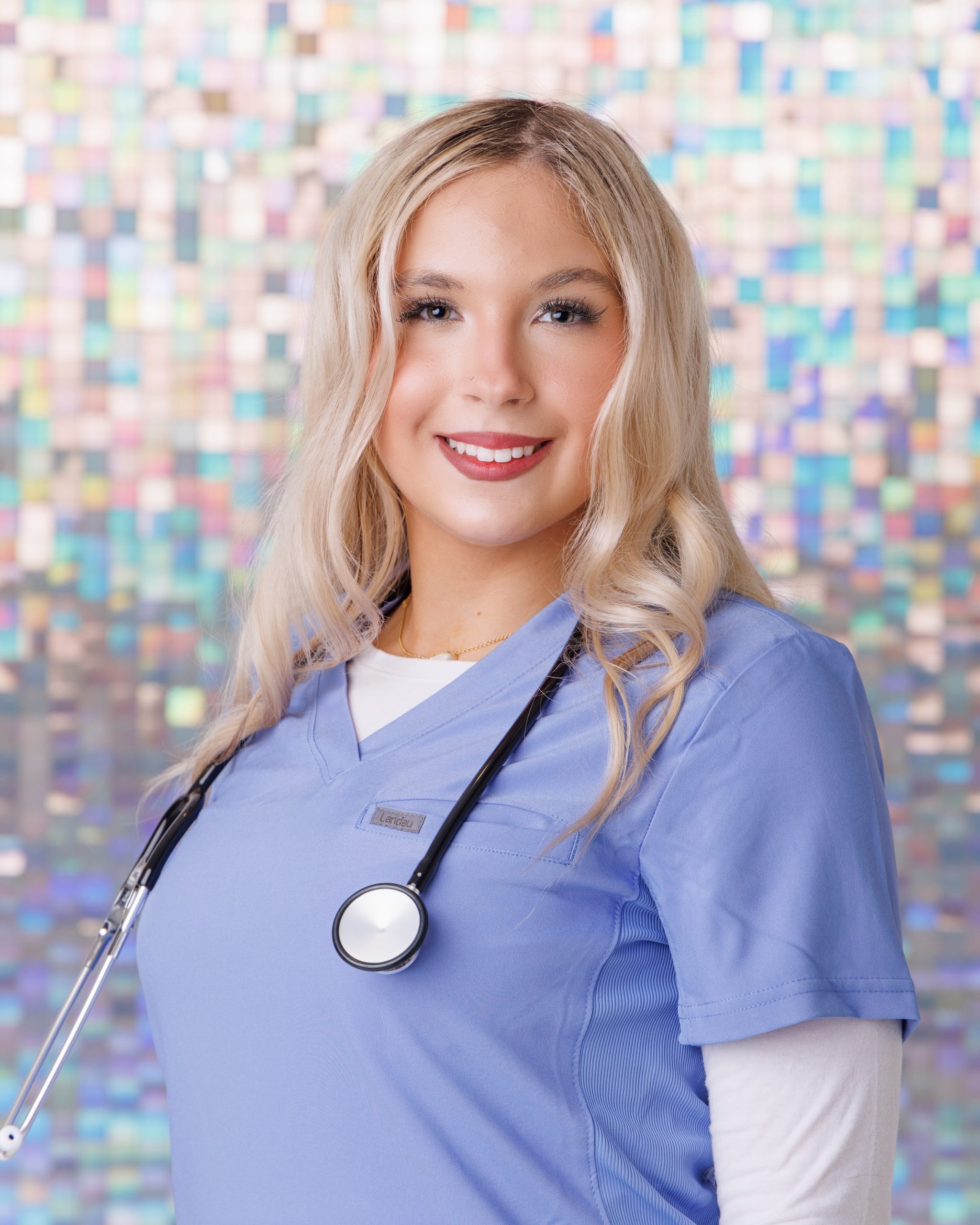 A woman wearing a white dress and long coat standing against a soft, snowy background