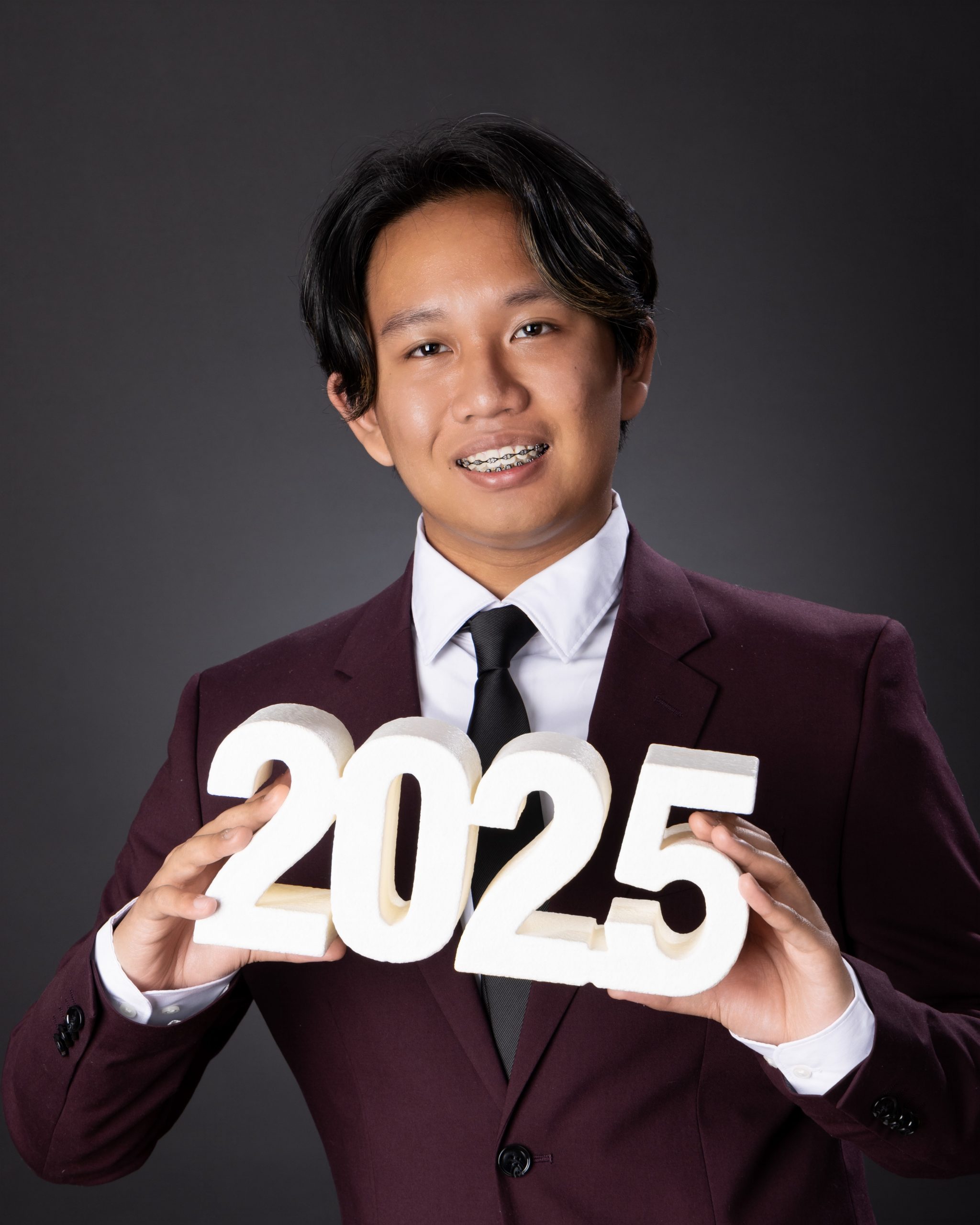 Eric holding 2025 numbers in Allen Park senior portrait session
