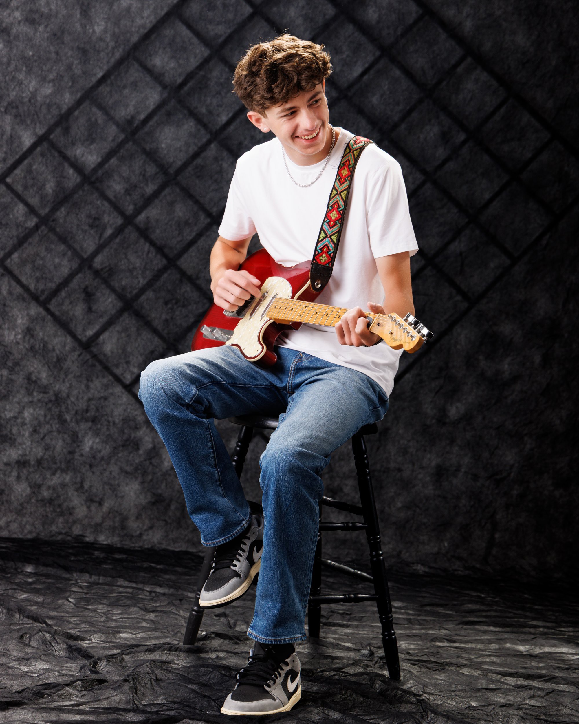Gavin Allen Park senior holding an acoustic guitar with handwritten notes