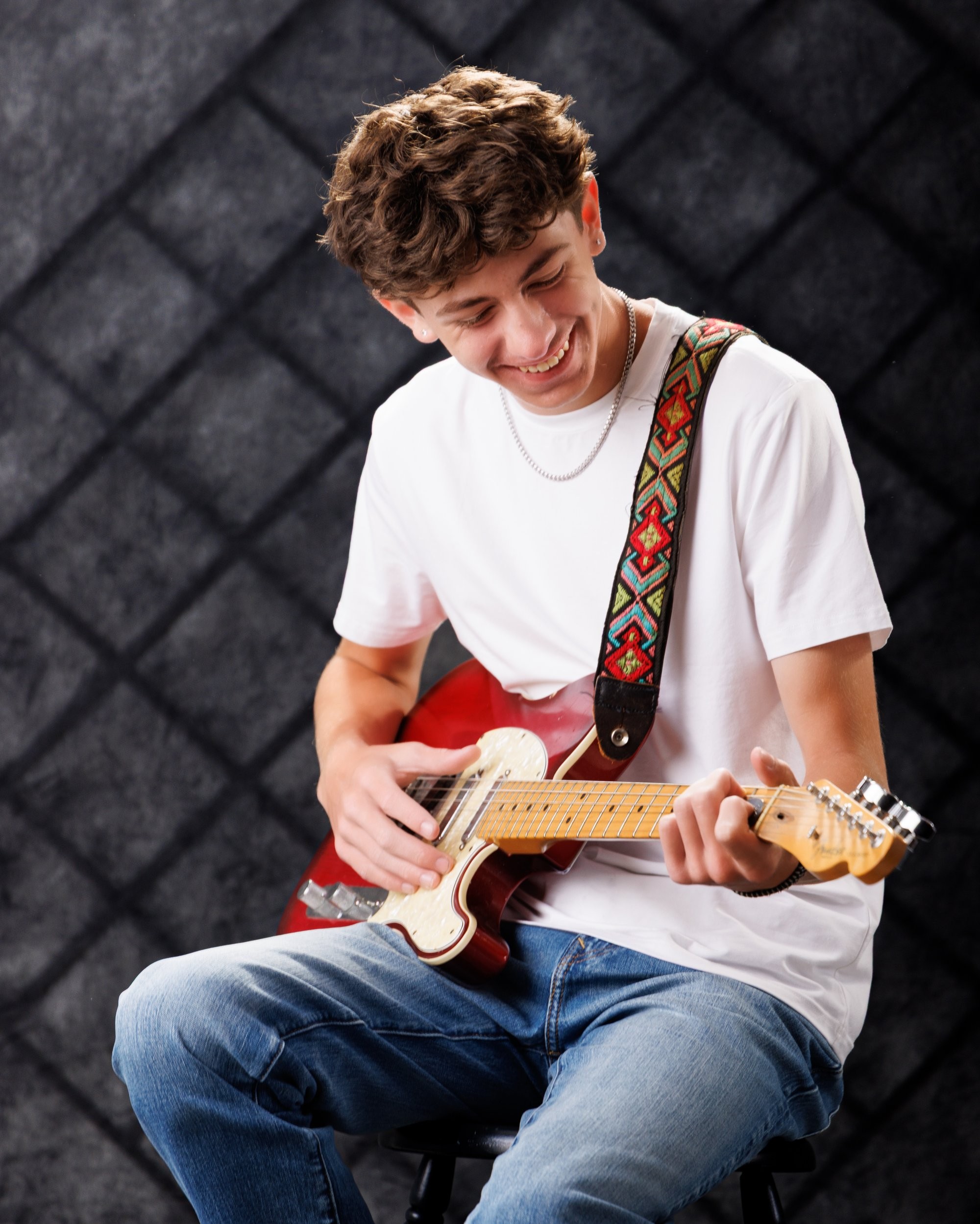 Gavin Allen Park senior holding an acoustic guitar with handwritten notes