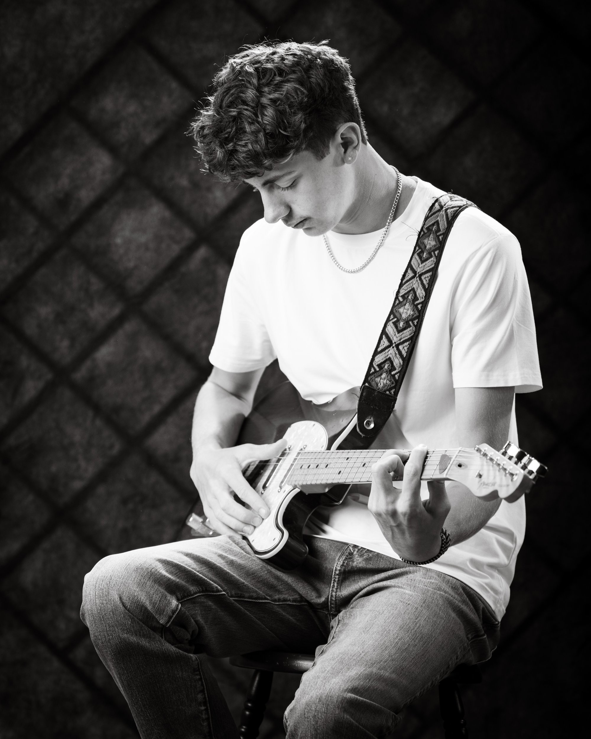 Gavin Allen Park senior holding an acoustic guitar with handwritten notes