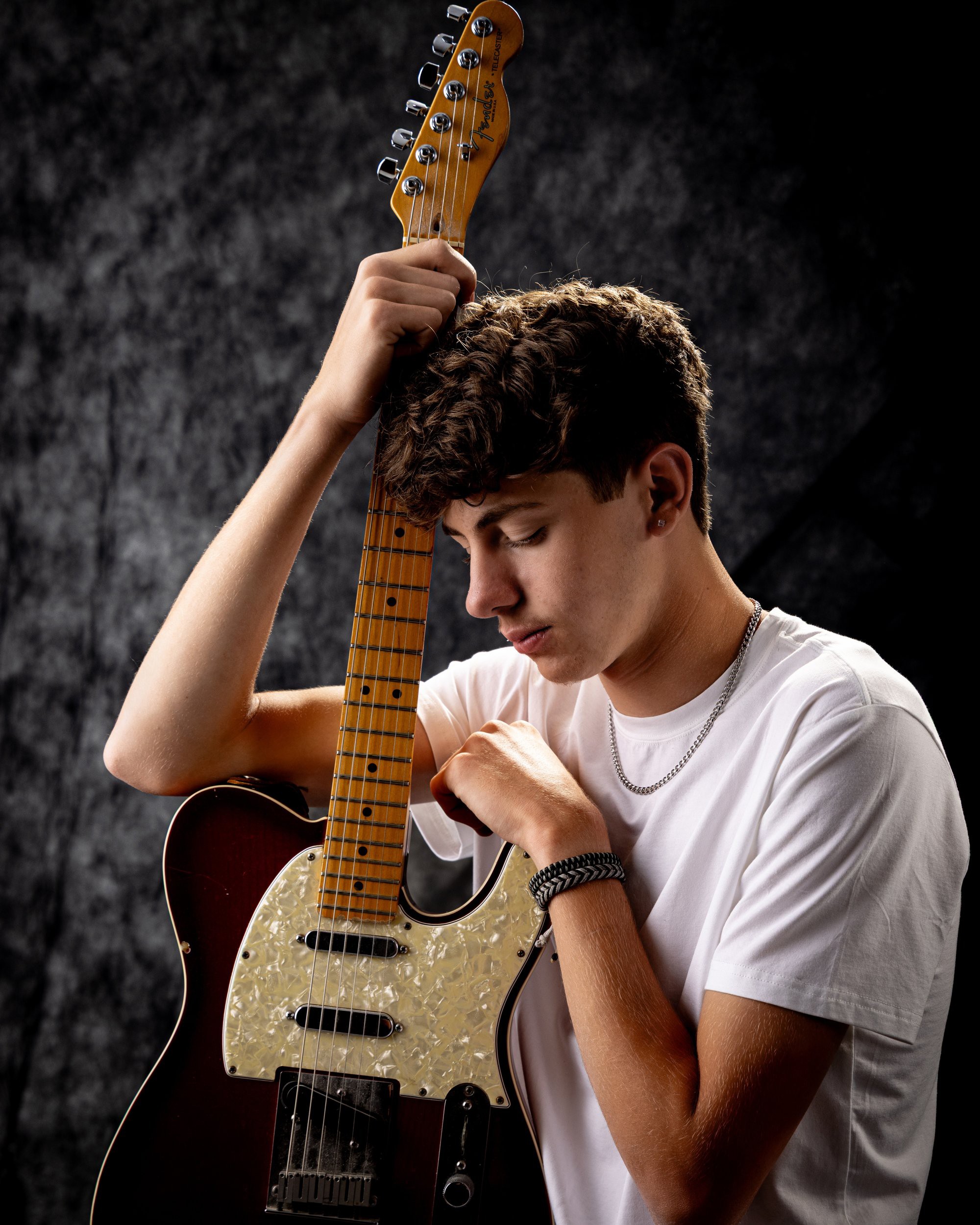Gavin Allen Park senior holding an acoustic guitar with handwritten notes