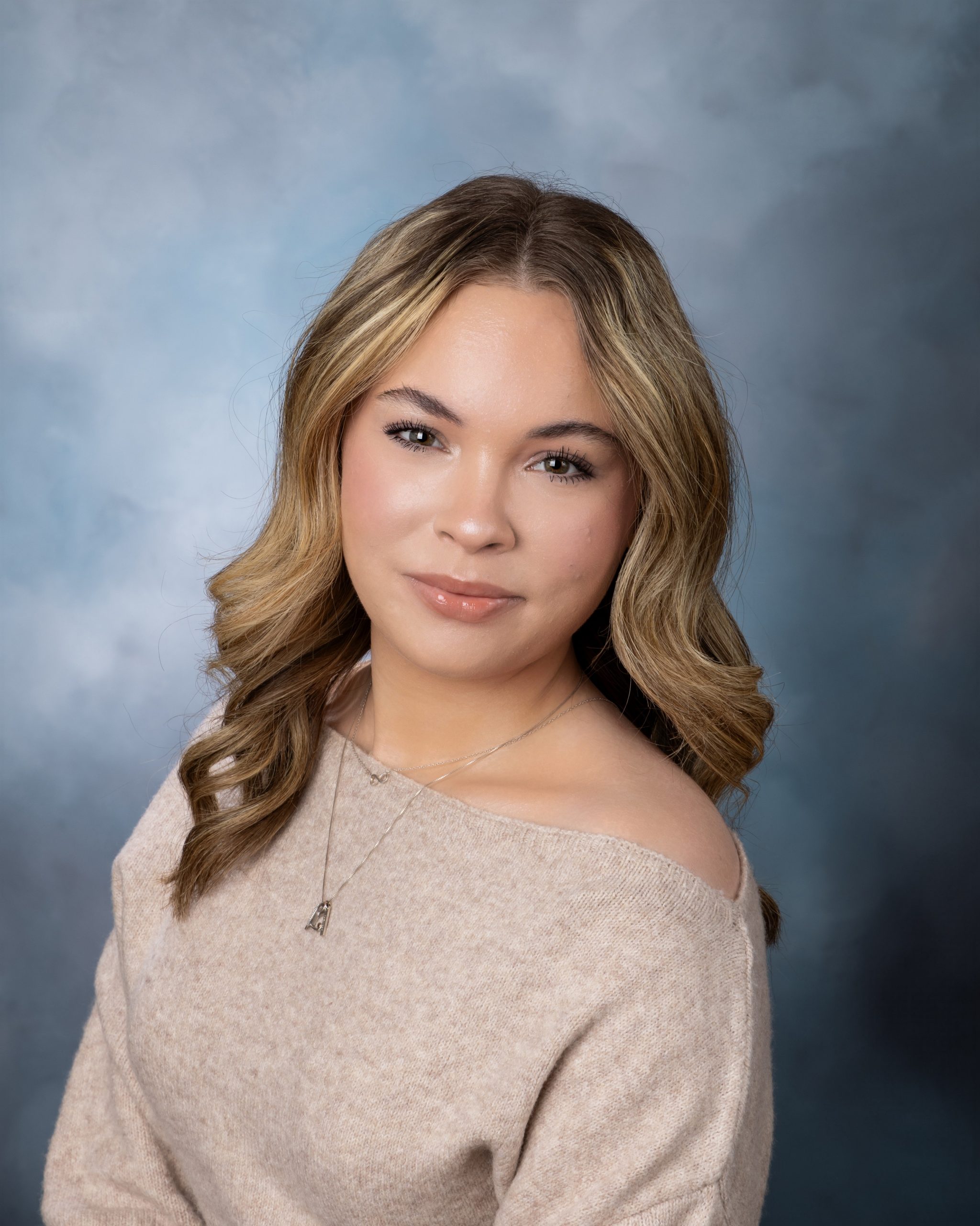 Lexi's off-shoulder sweater portrait in an Allen Park senior photography session with soft blue backdrop