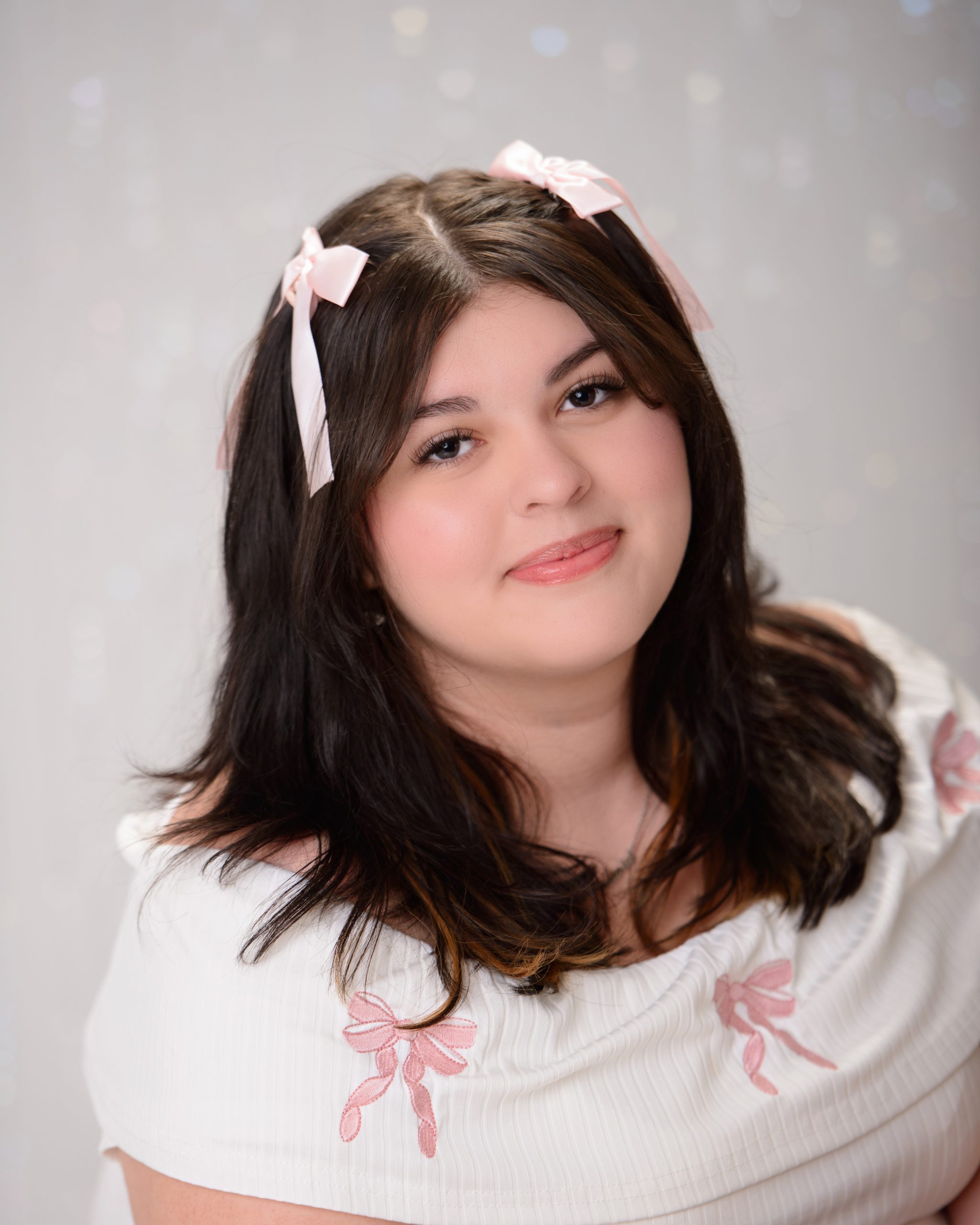 senior portrait of young woman with pink hair accessories in Allen Park studio session