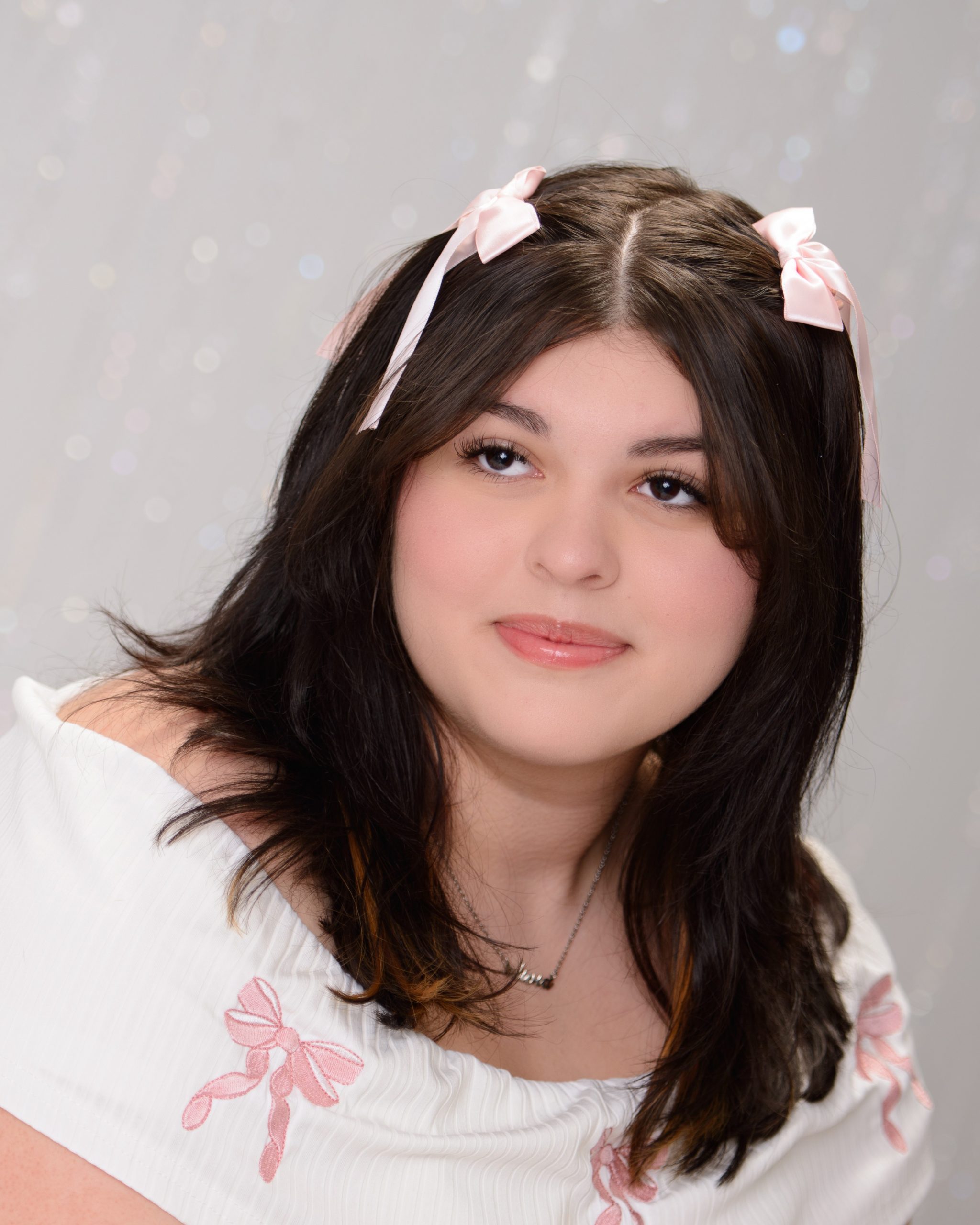 senior portrait of young woman with pink hair accessories in Allen Park studio session