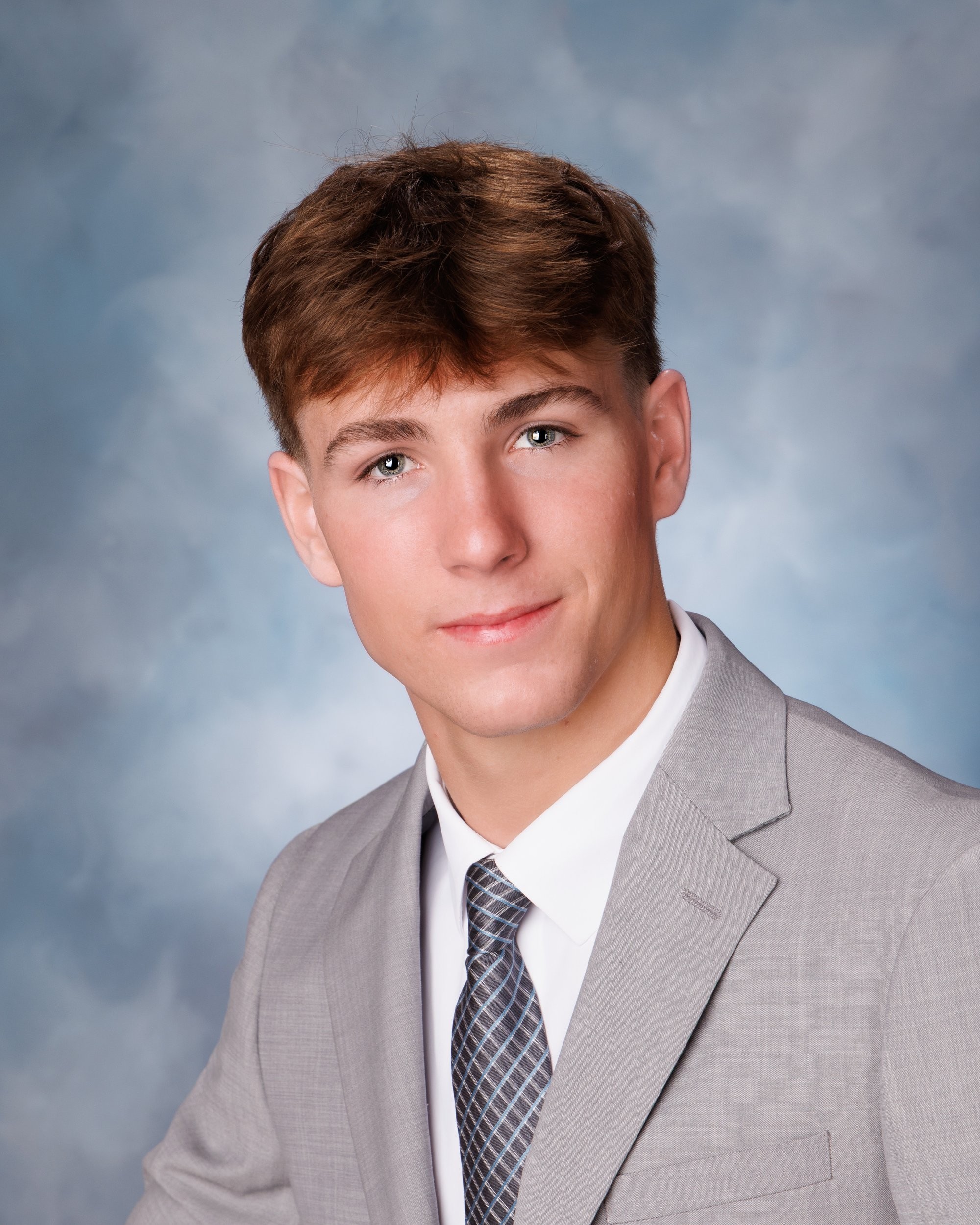 Sam holding lacrosse stick and helmet for Allen Park senior photoshoot