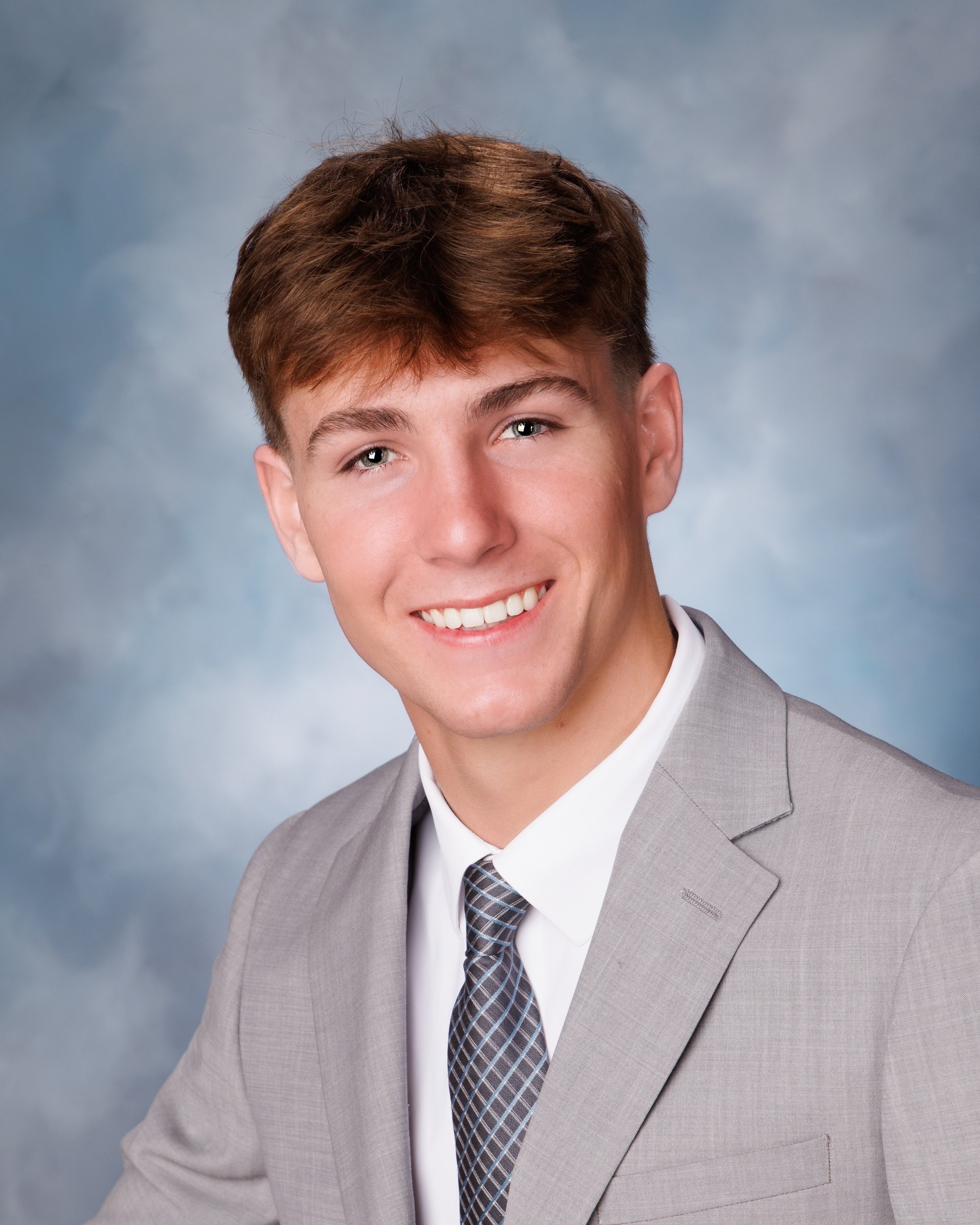 Allen Park senior Sam with football, basketball, and sports gear in studio portrait