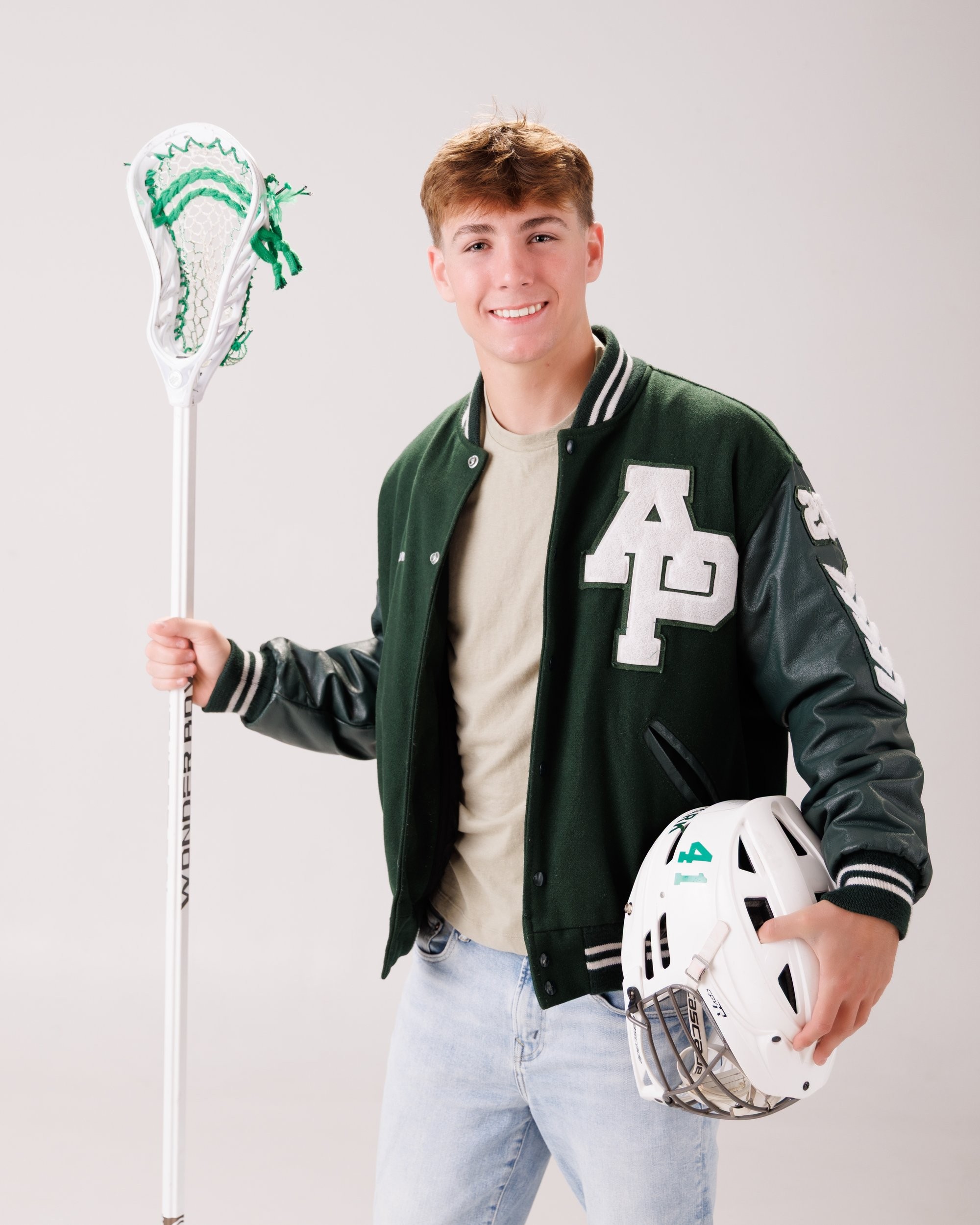 Allen Park senior Sam with football, basketball, and sports gear in studio portrait