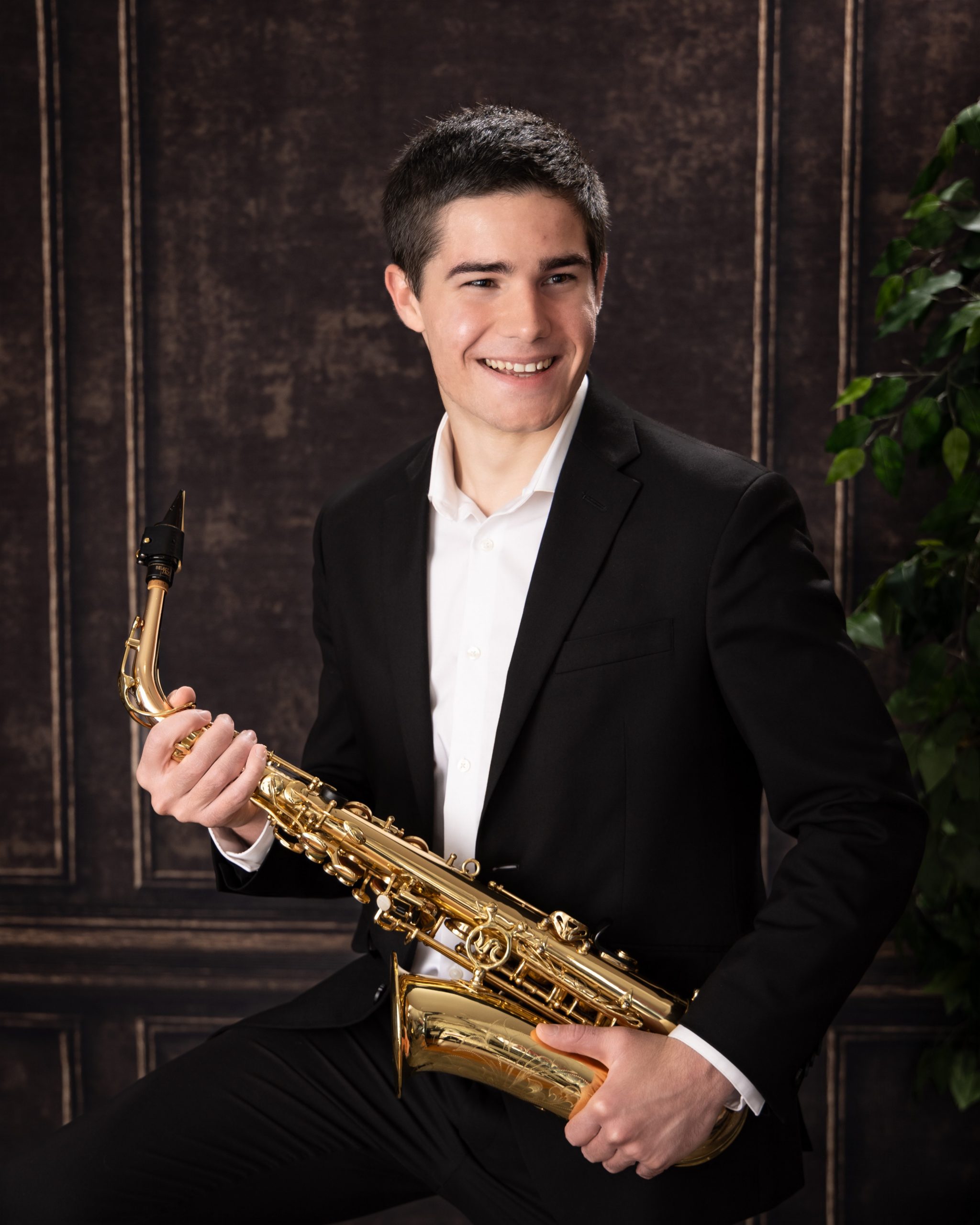 Saxophone instrument held by high school senior in Wyandotte photo shoot