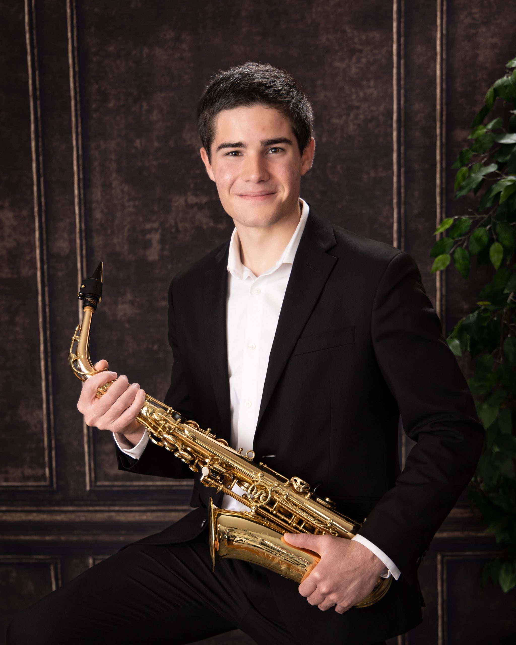 Saxophone instrument held by high school senior in Wyandotte photo shoot