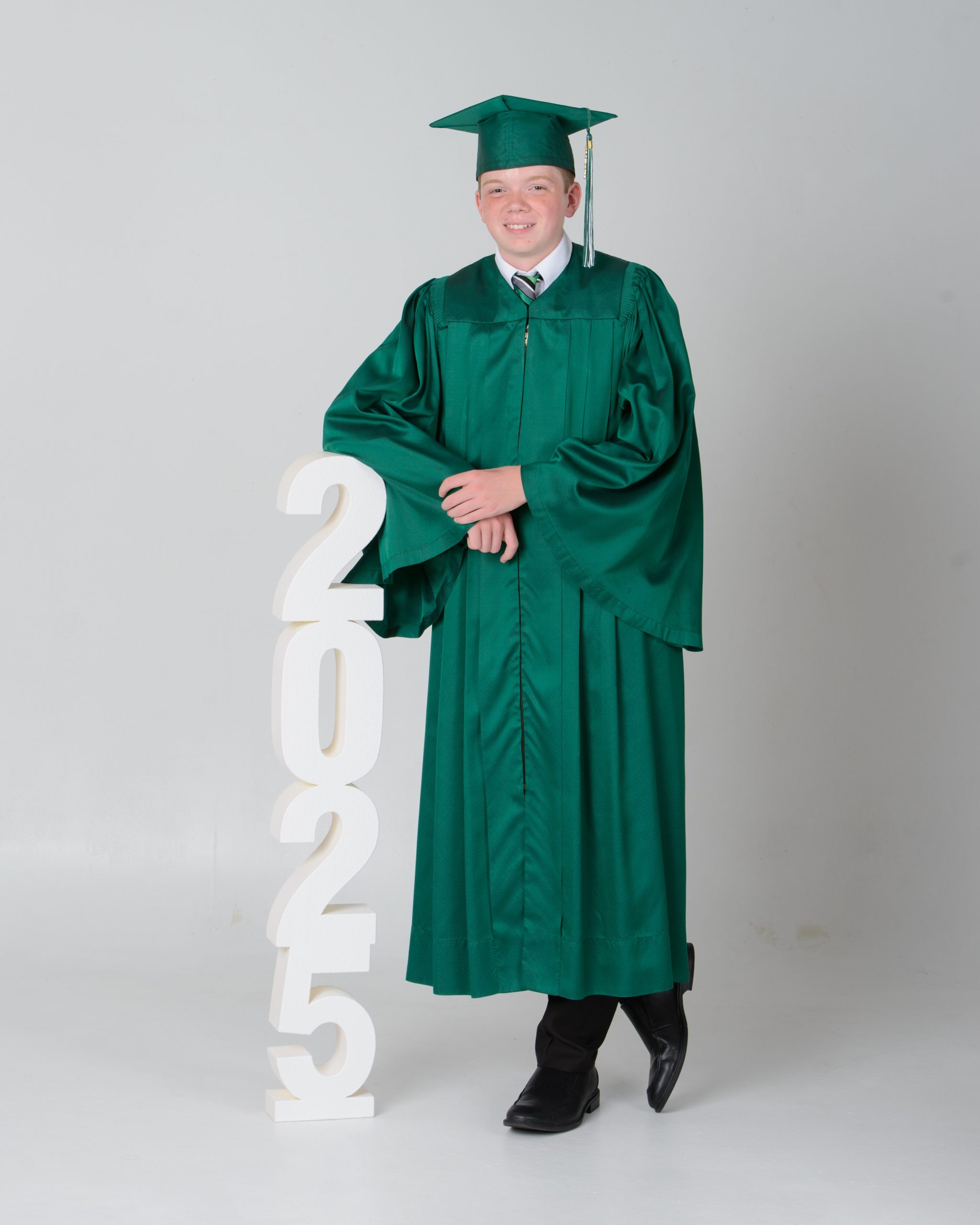 Allen Park 2025 graduate in green cap and gown