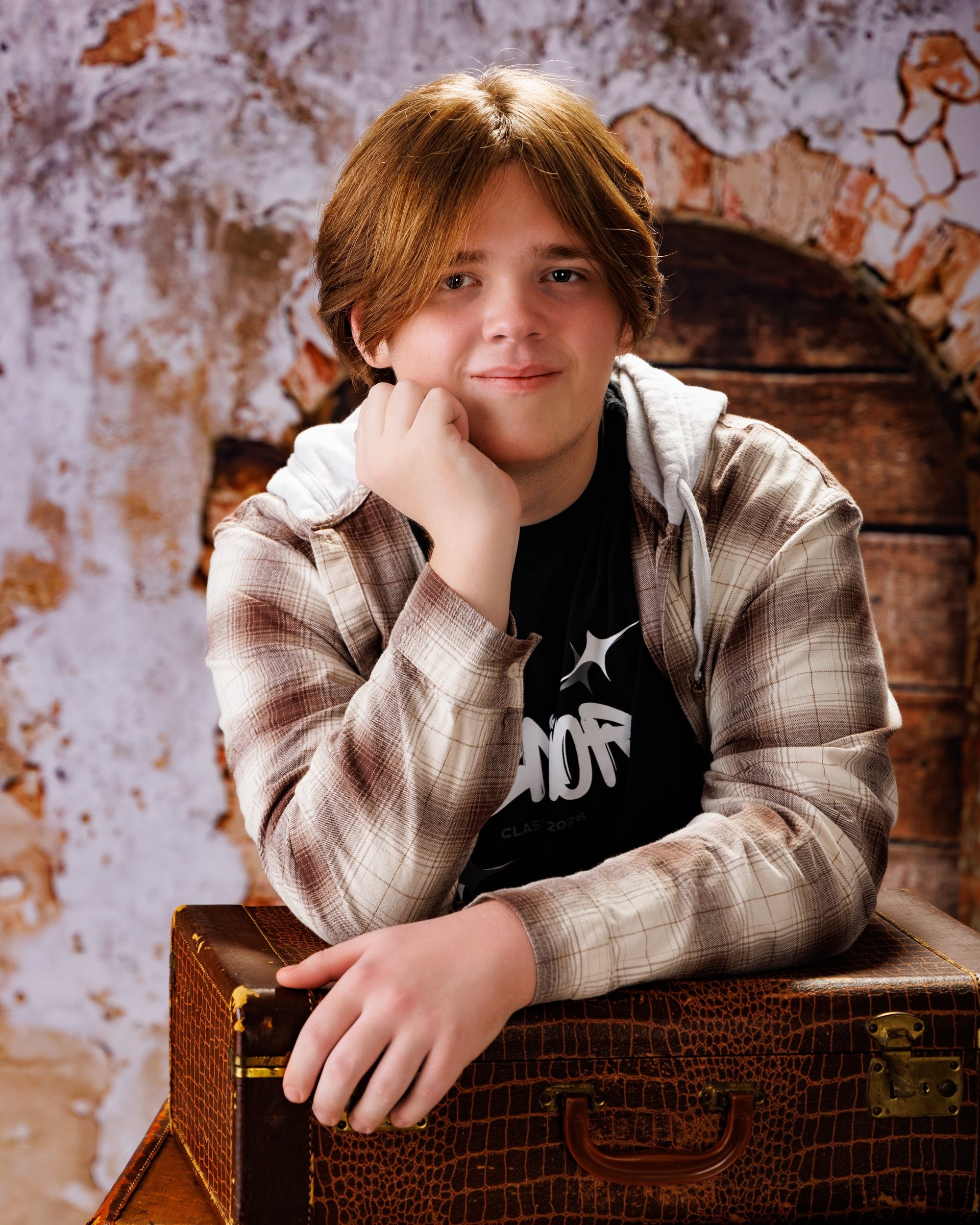 Senior portrait featuring an acoustic guitar against a dark gradient background, showcasing the artist's style in our Taylor photo studio