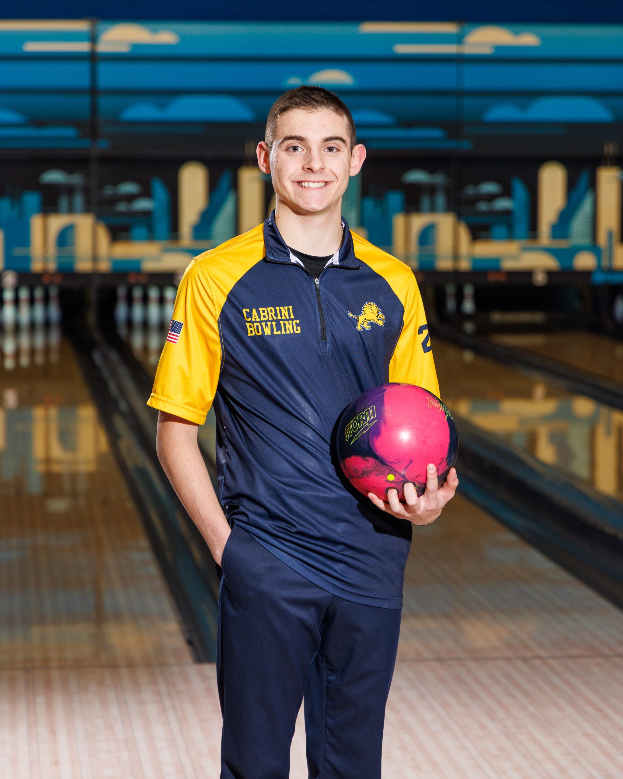 Cabrini Bowling player lying on floor with red bowling ball