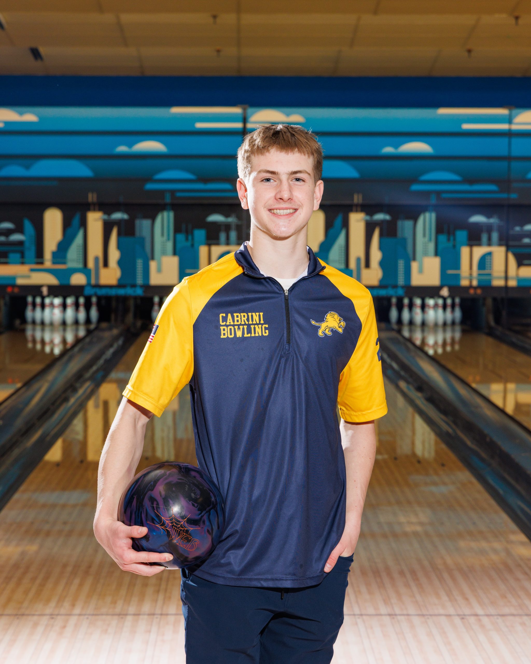 Cabrini Bowling player lying on floor with red bowling ball