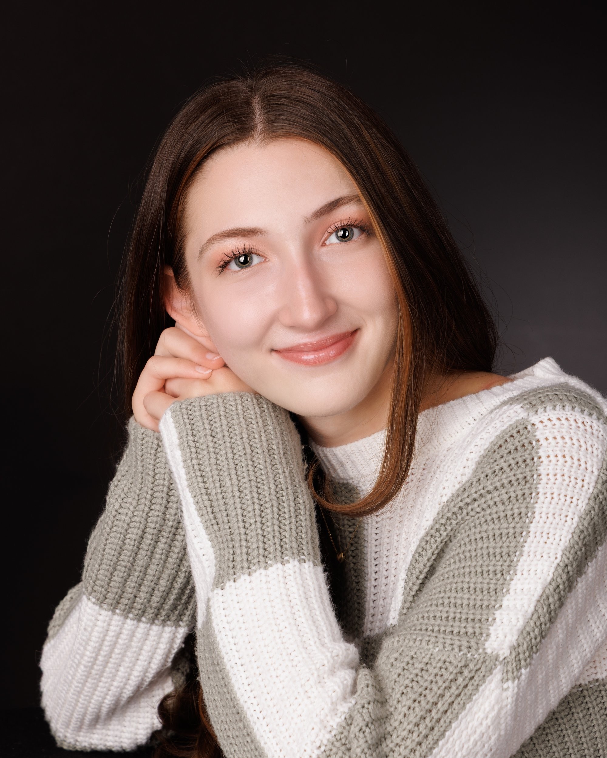 Emma holding 'Class of 2026' chalkboard in senior photography session
