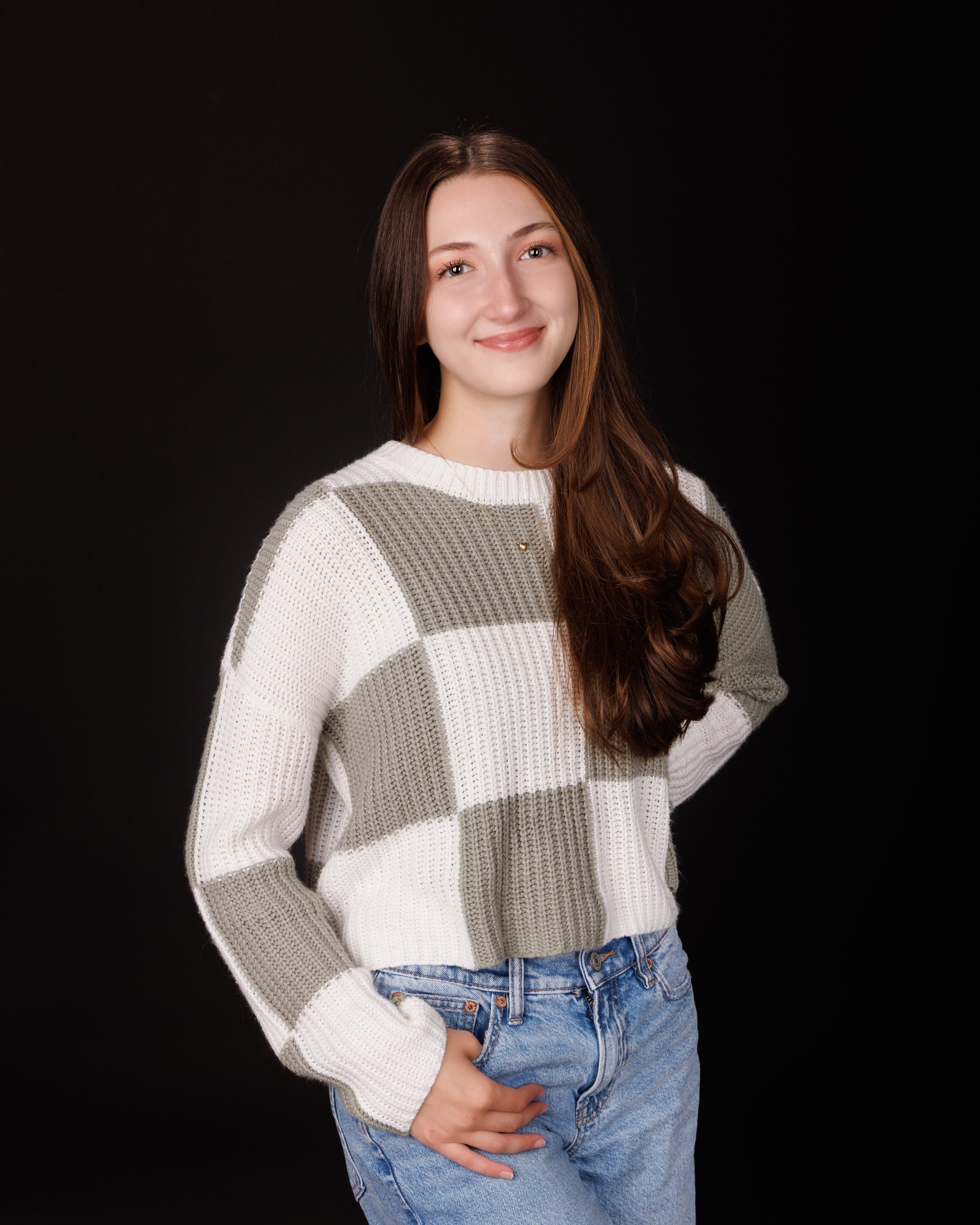 Emma holding 'Class of 2026' chalkboard in senior photography session