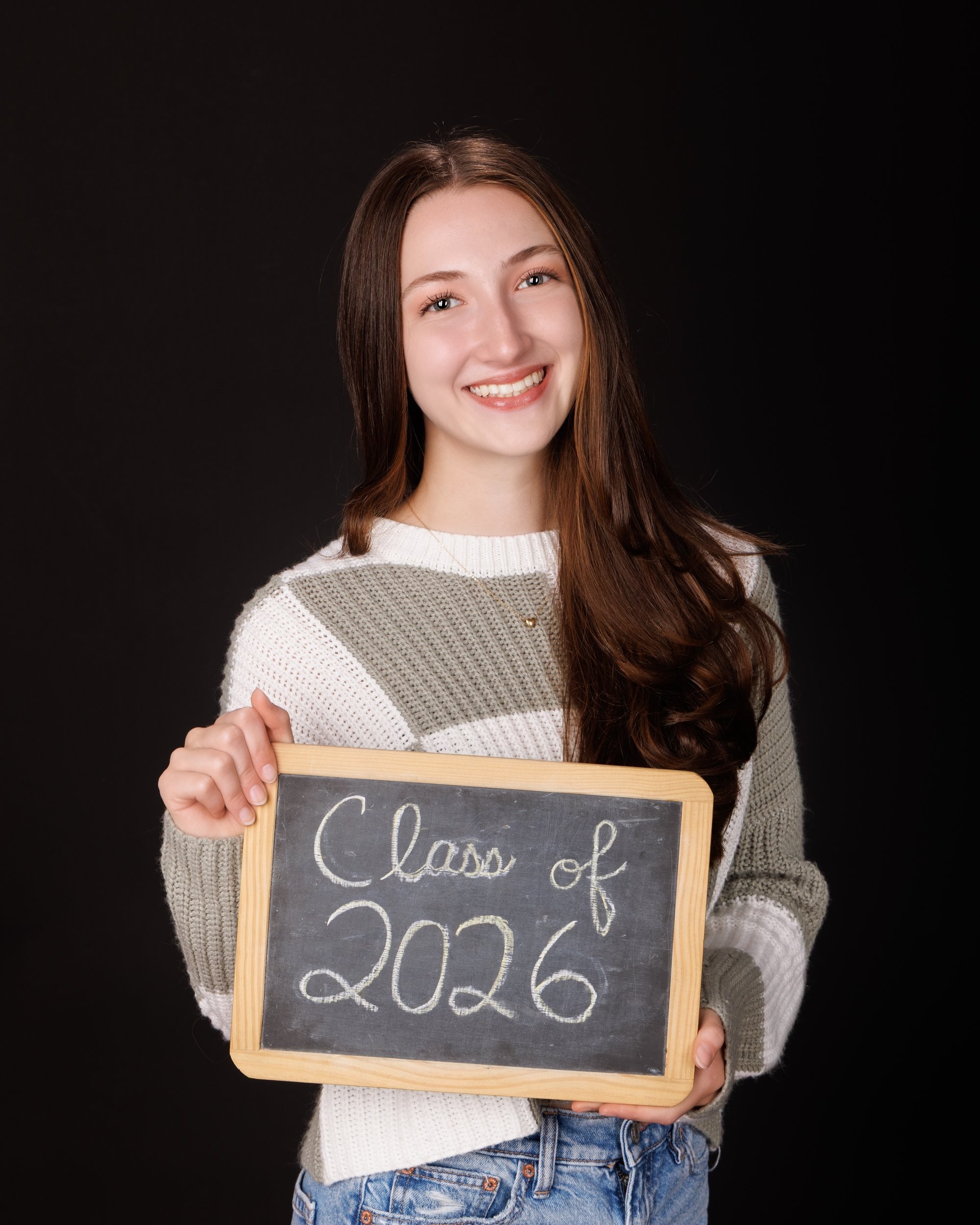 Emma holding 'Class of 2026' chalkboard in senior photography session