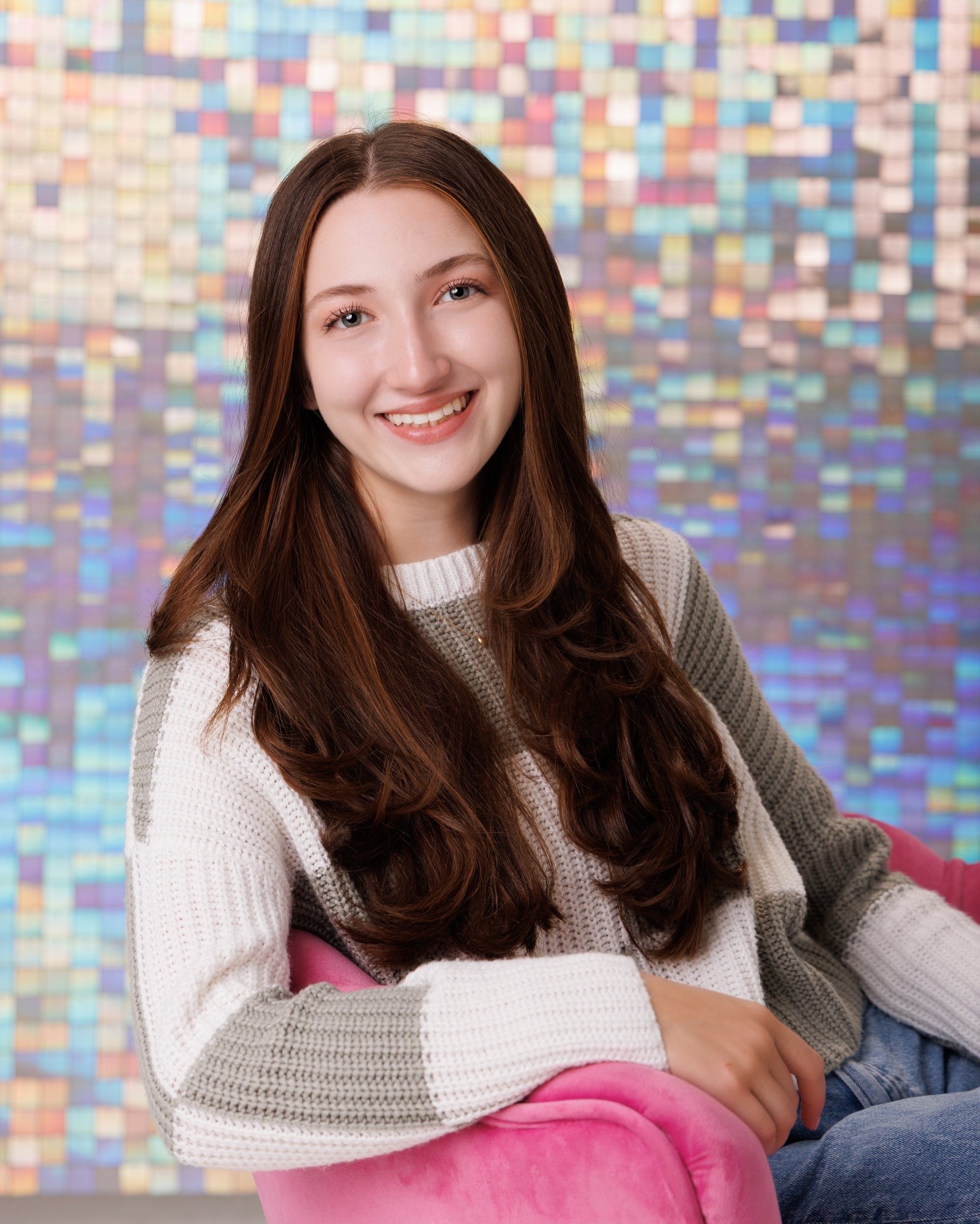 Emma holding 'Class of 2026' chalkboard in senior photography session