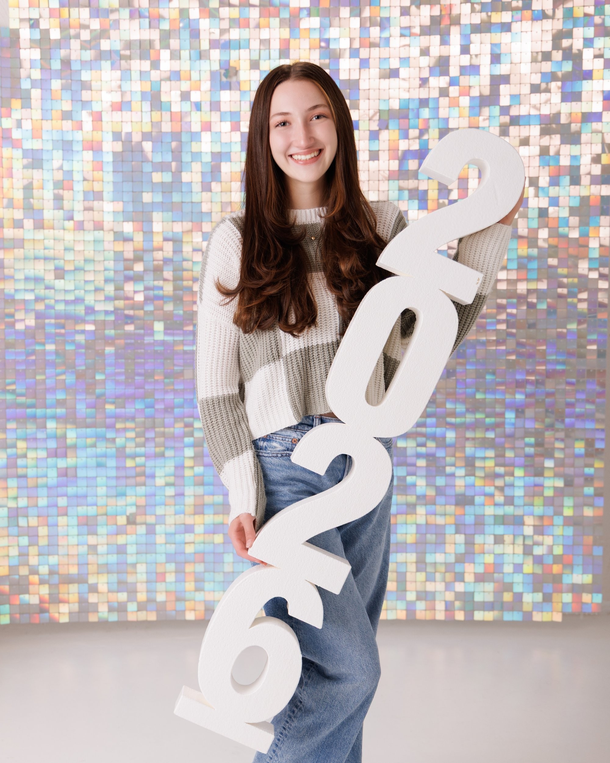 Emma holding 'Class of 2026' chalkboard in senior photography session