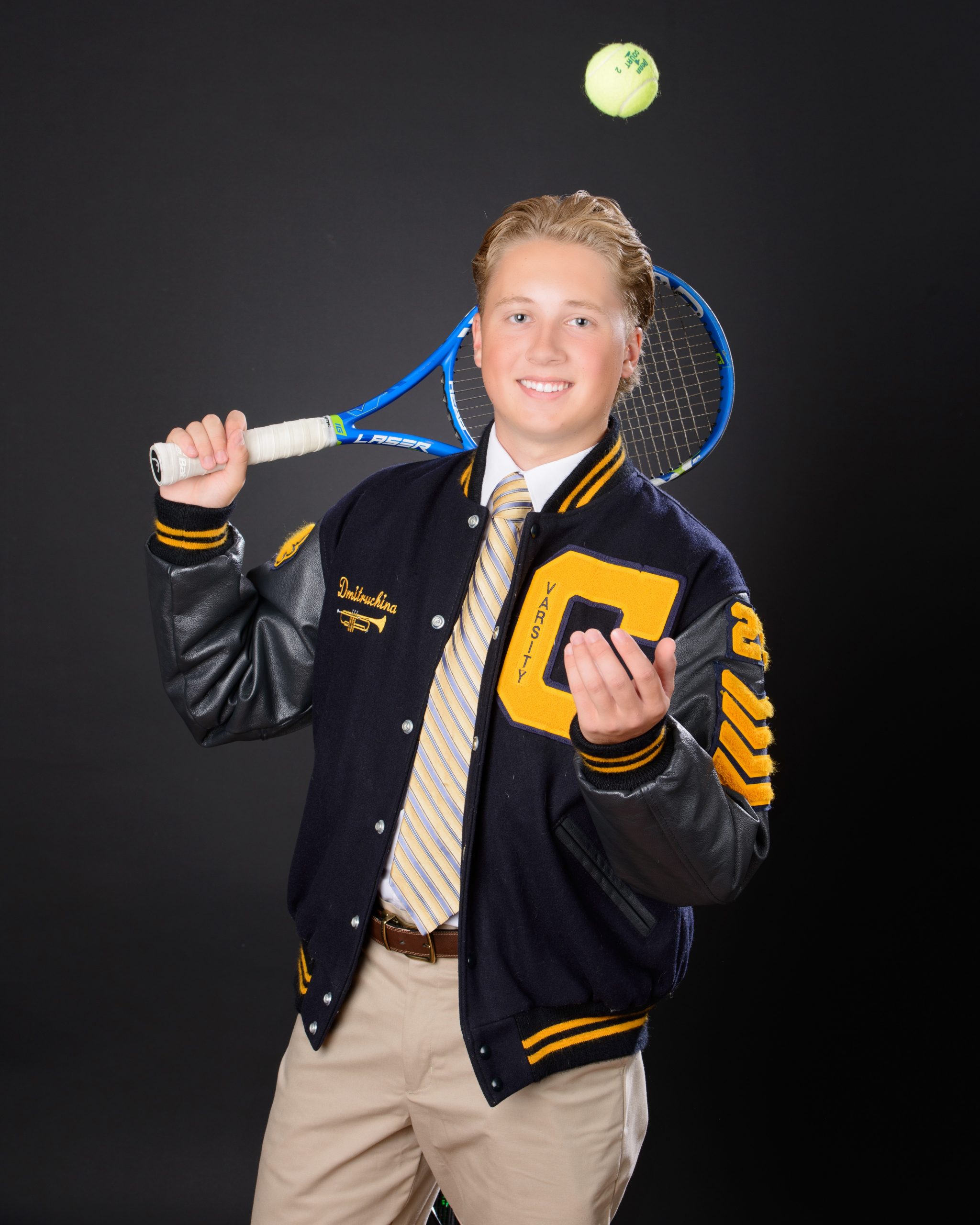 Matt in Cabrini varsity jacket, hands in pockets, senior photography