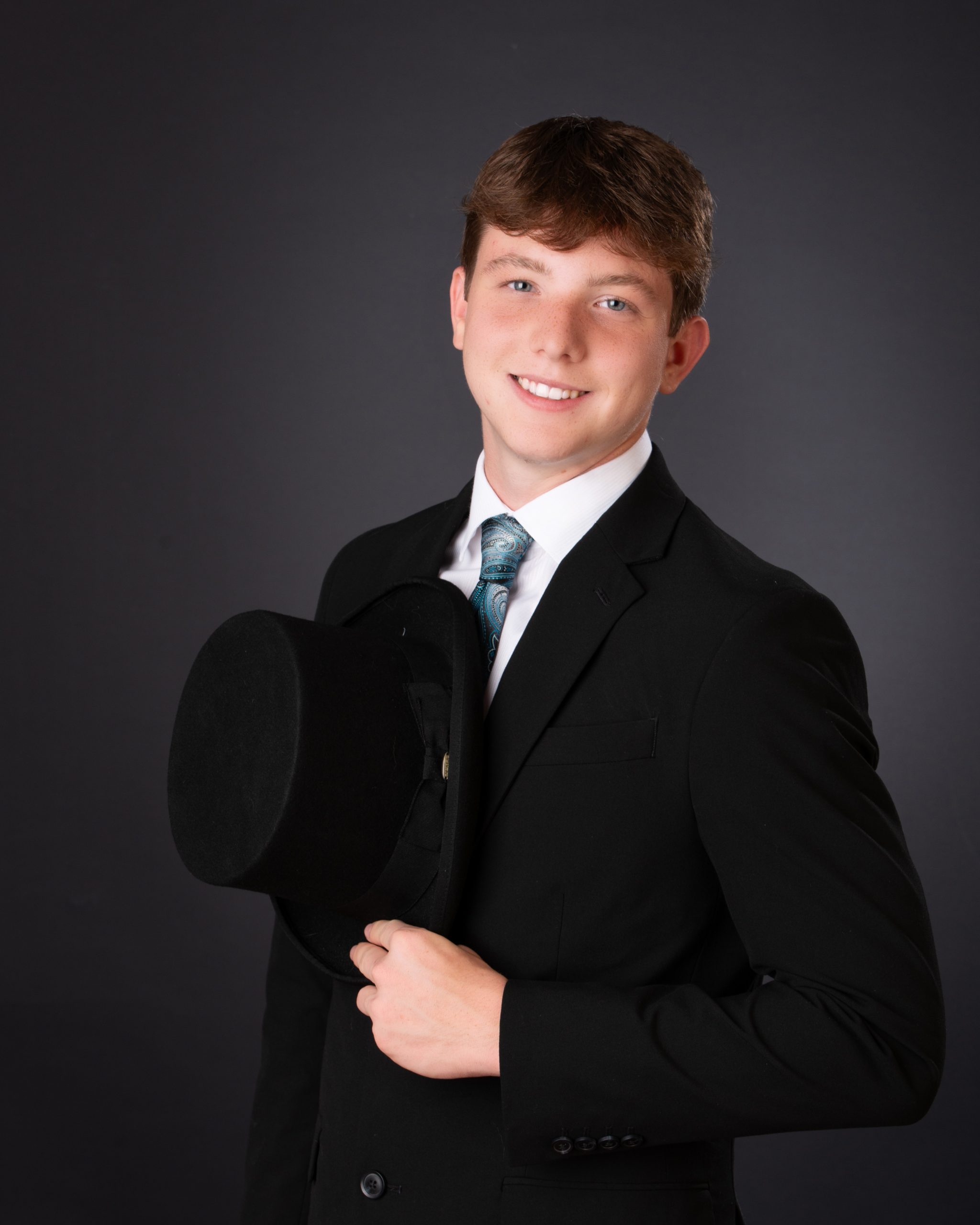 Wyatt in black Nike hoodie with graffiti art backdrop for senior photography session