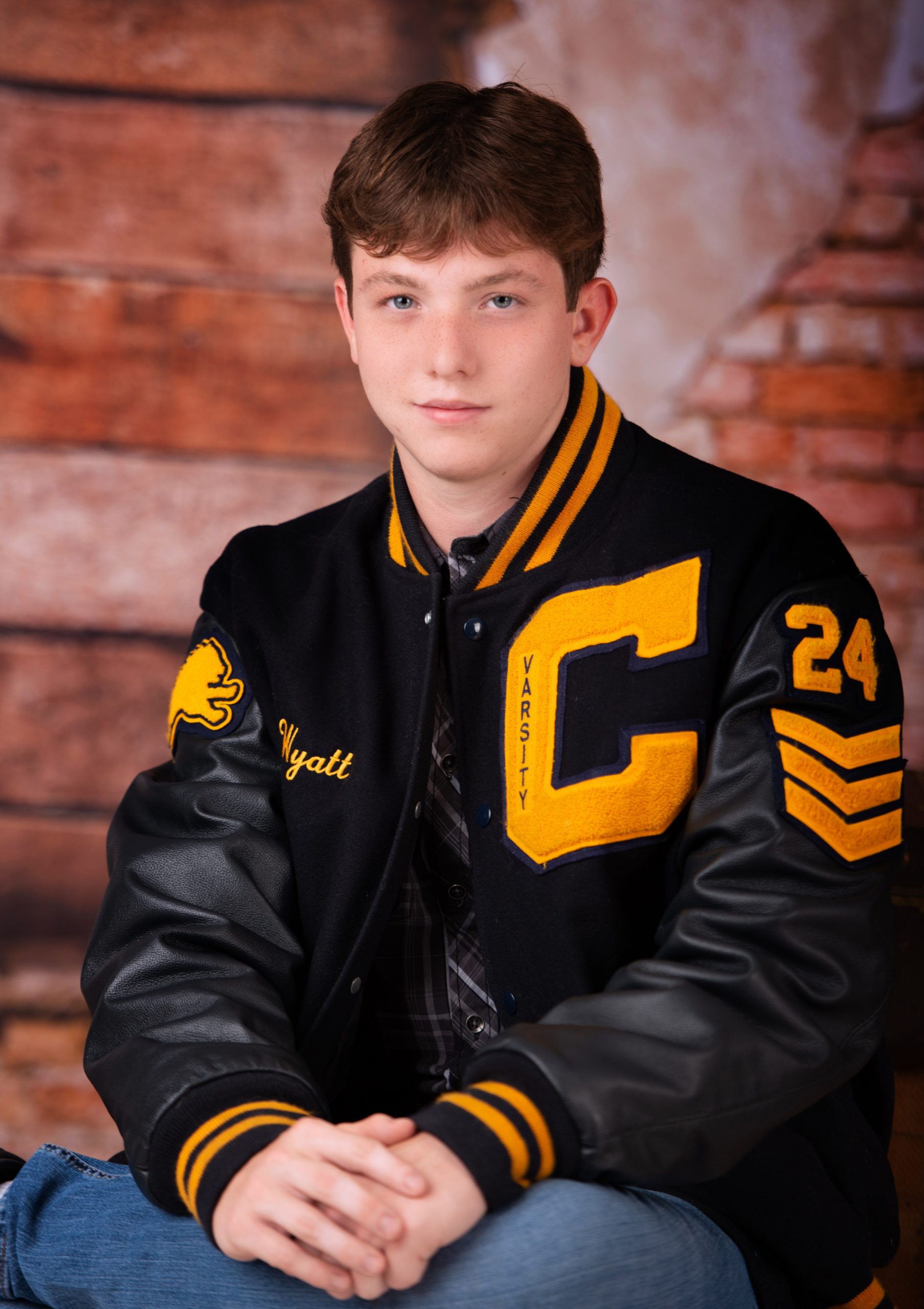 Wyatt in black Nike hoodie with graffiti art backdrop for senior photography session