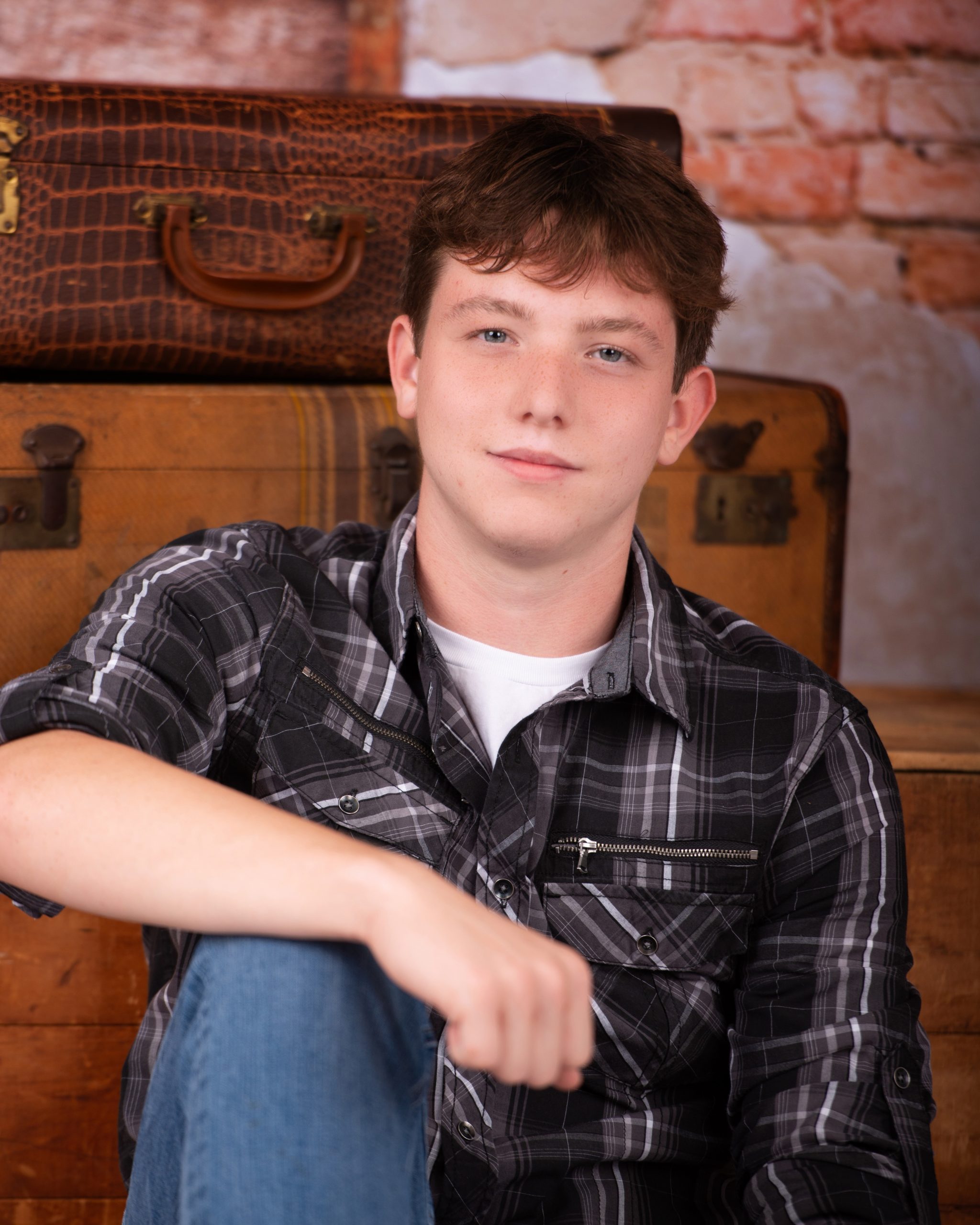 Wyatt in black Nike hoodie with graffiti art backdrop for senior photography session