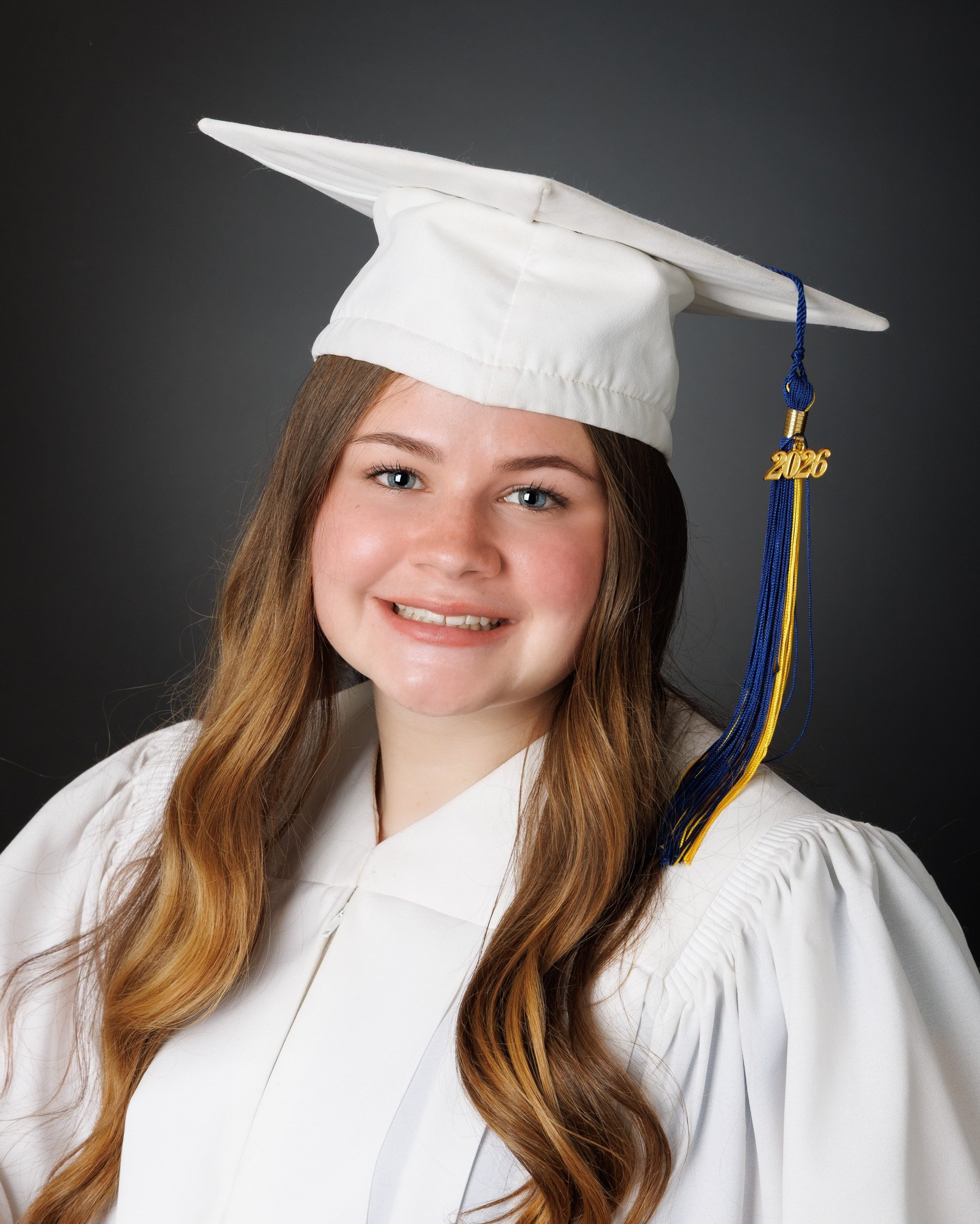 Natalie in blue dress and varsity jacket for Cabrini Senior Session photo shoot