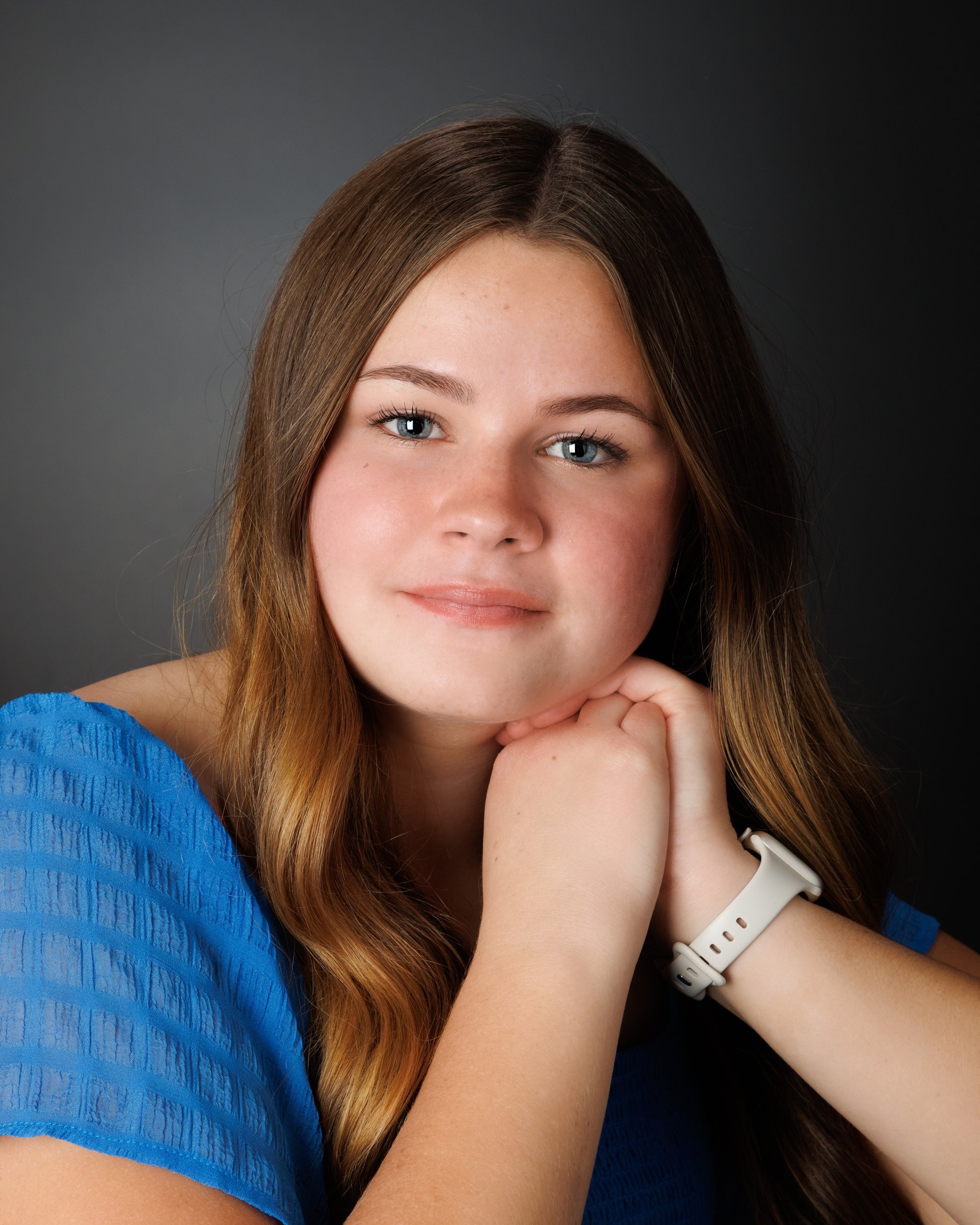 Natalie in blue dress and varsity jacket for Cabrini Senior Session photo shoot