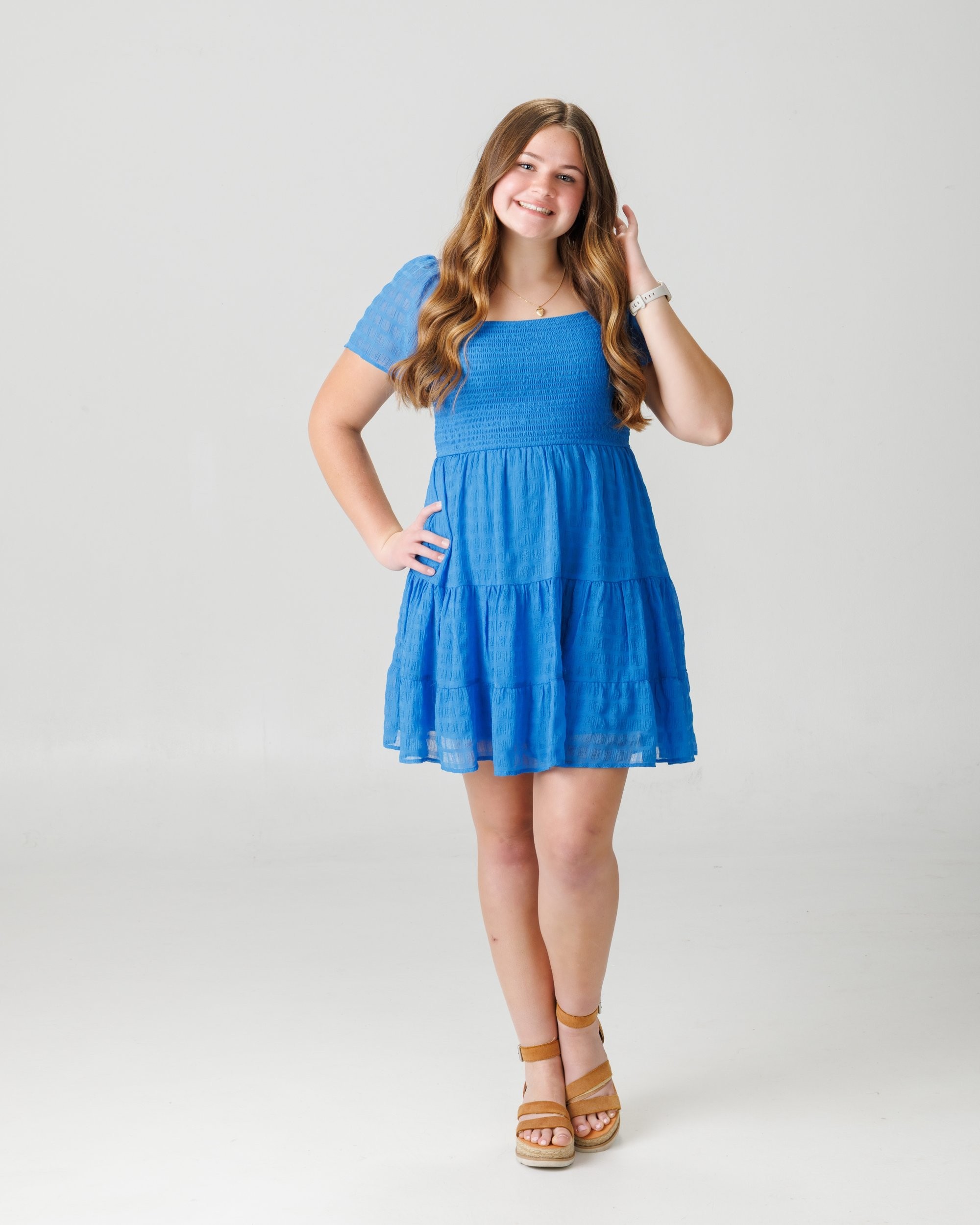 Natalie in blue dress and varsity jacket for Cabrini Senior Session photo shoot