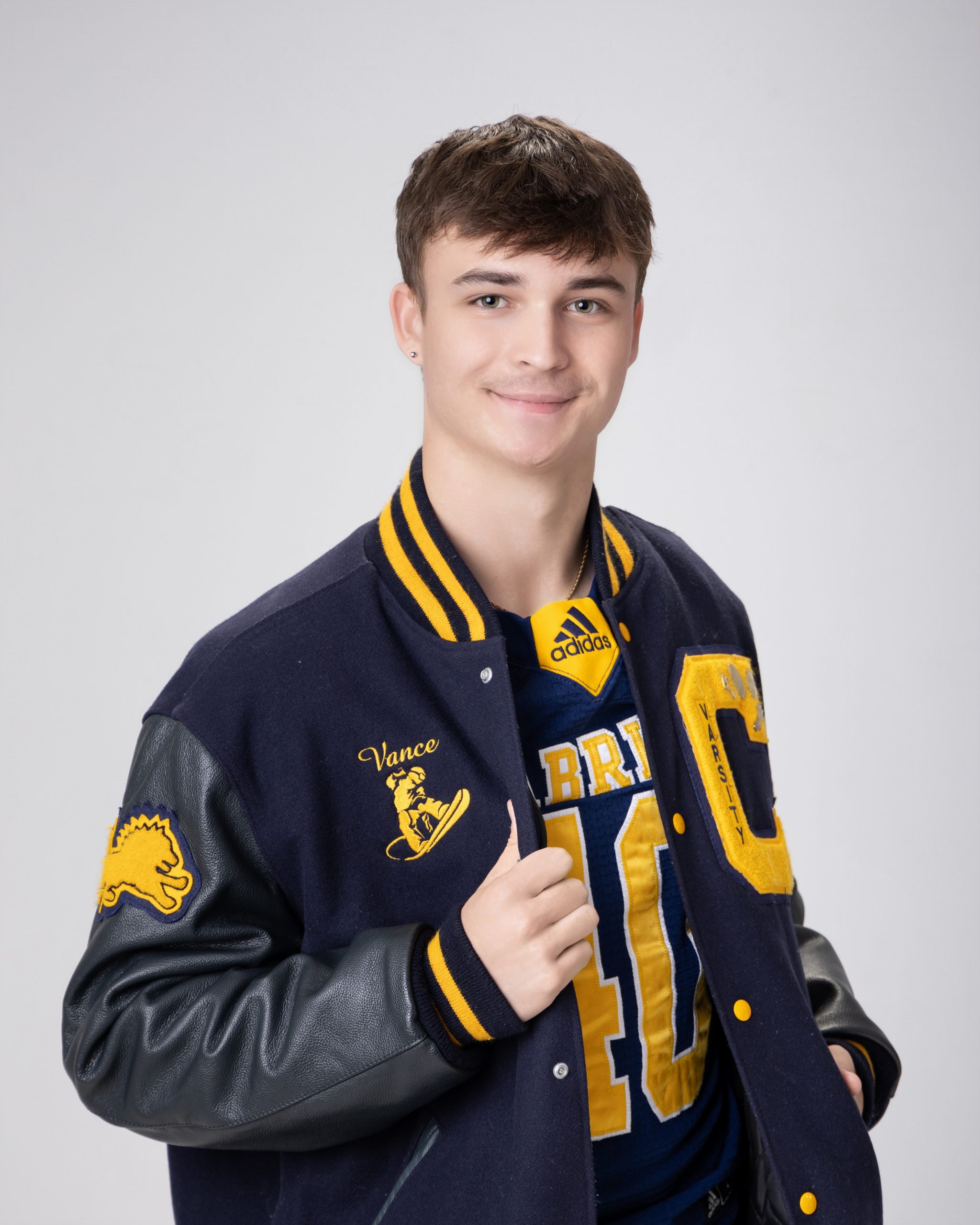 Cabrini Senior Vance sports jersey and jacket, blue and gold school colors, Downriver photo session