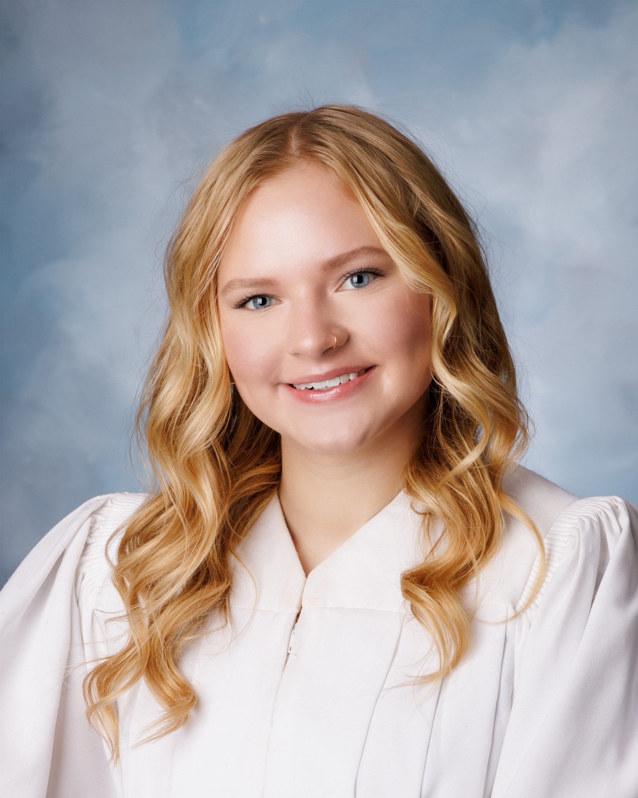 Female student in soft pink sweater with long hair for Cabrini senior yearbook photo