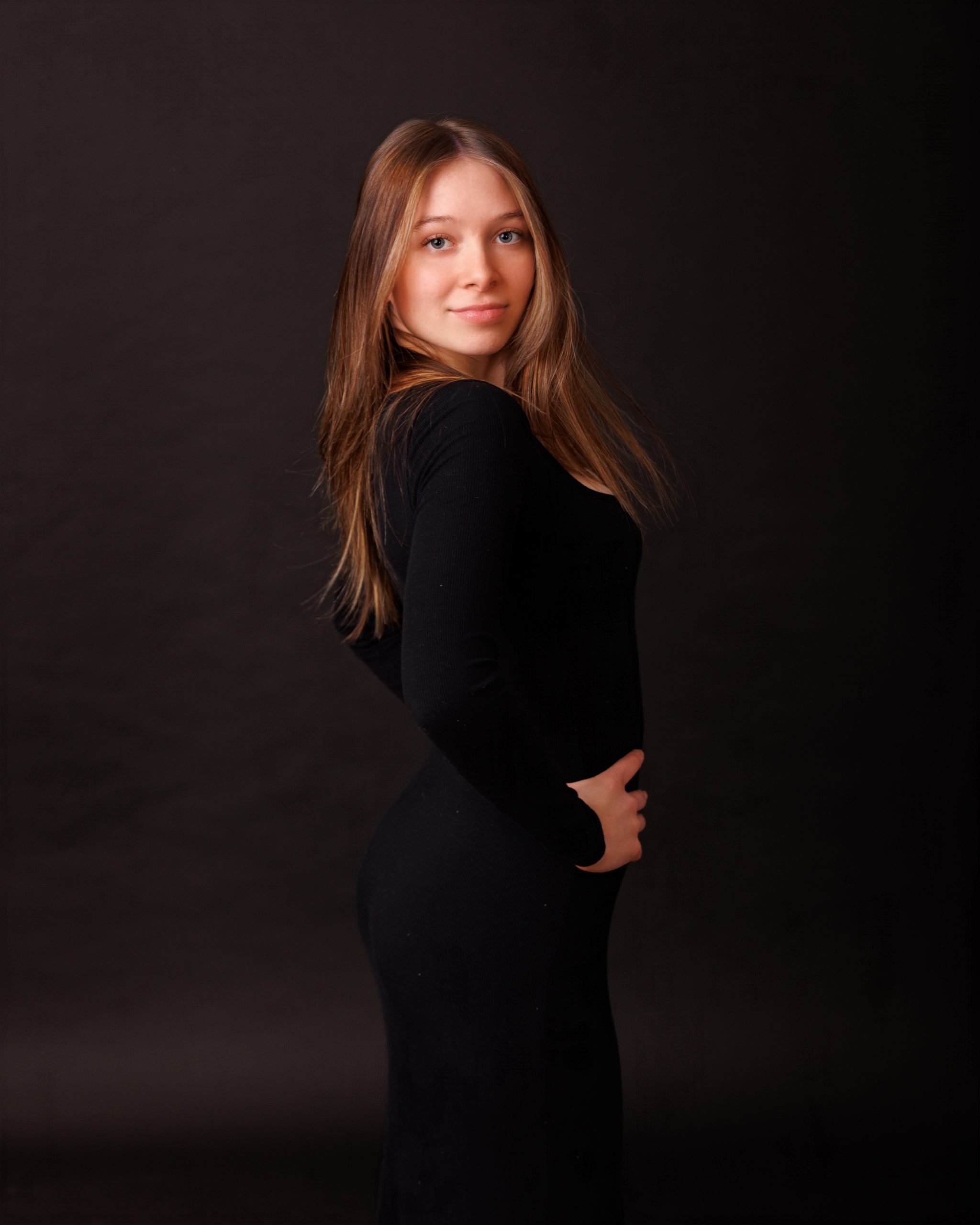 Hailey posing with graduation cap in floral dress during Downriver senior photo shoot