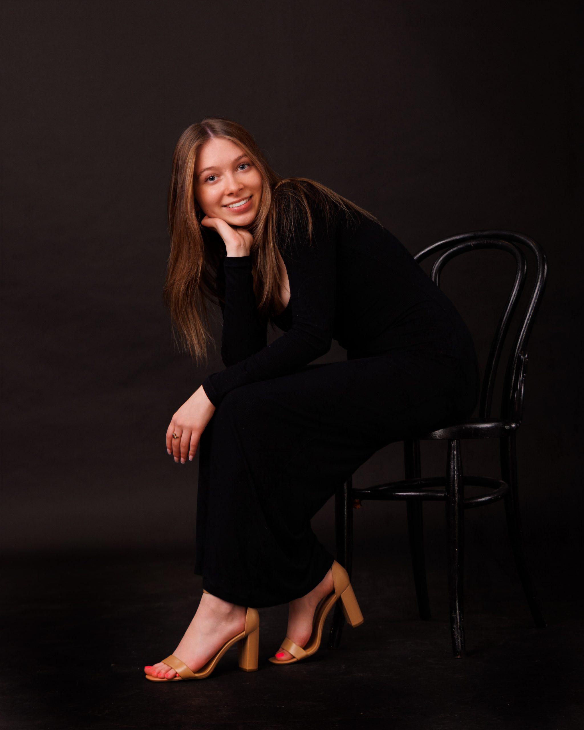 Hailey posing with graduation cap in floral dress during Downriver senior photo shoot