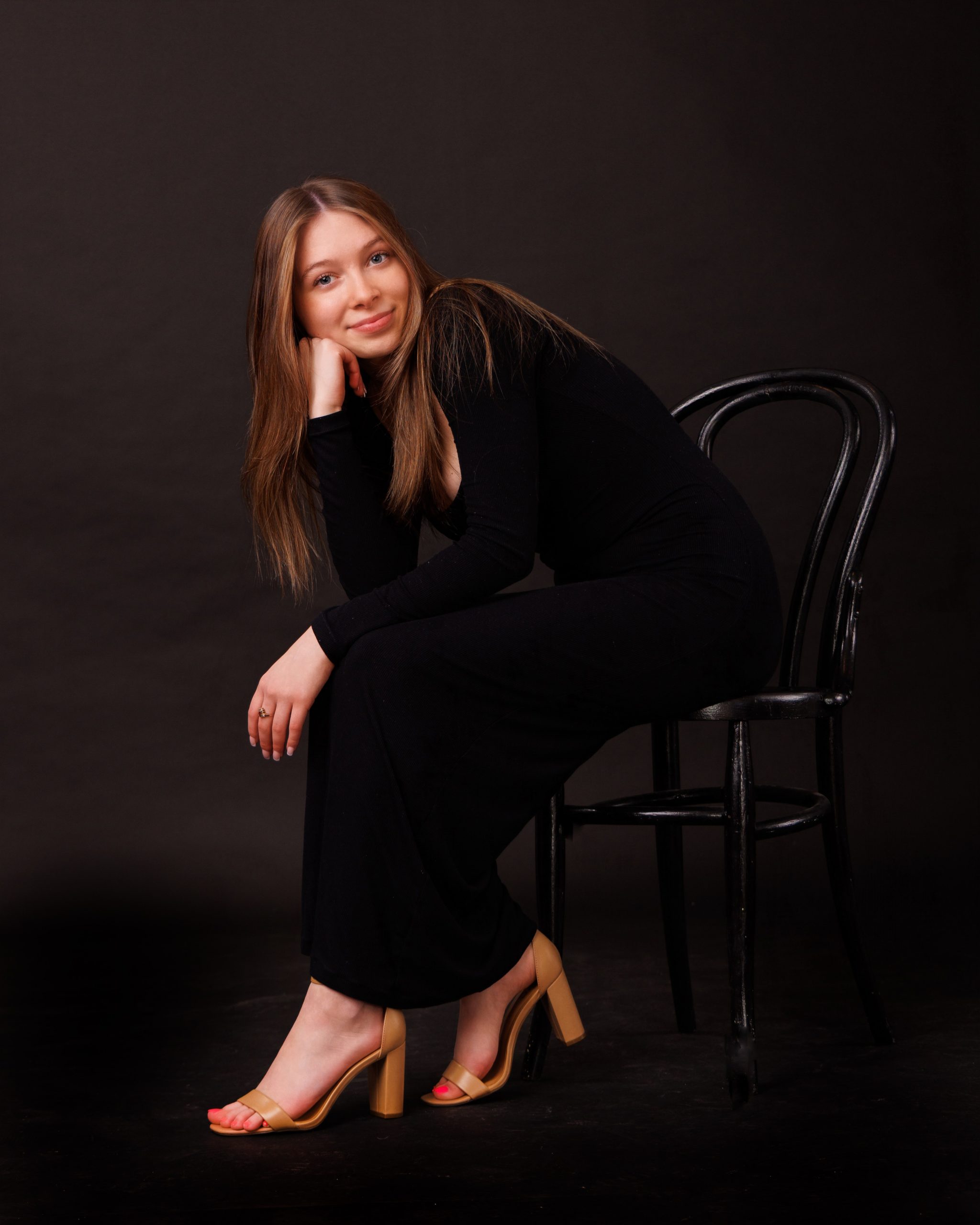 Hailey posing with graduation cap in floral dress during Downriver senior photo shoot