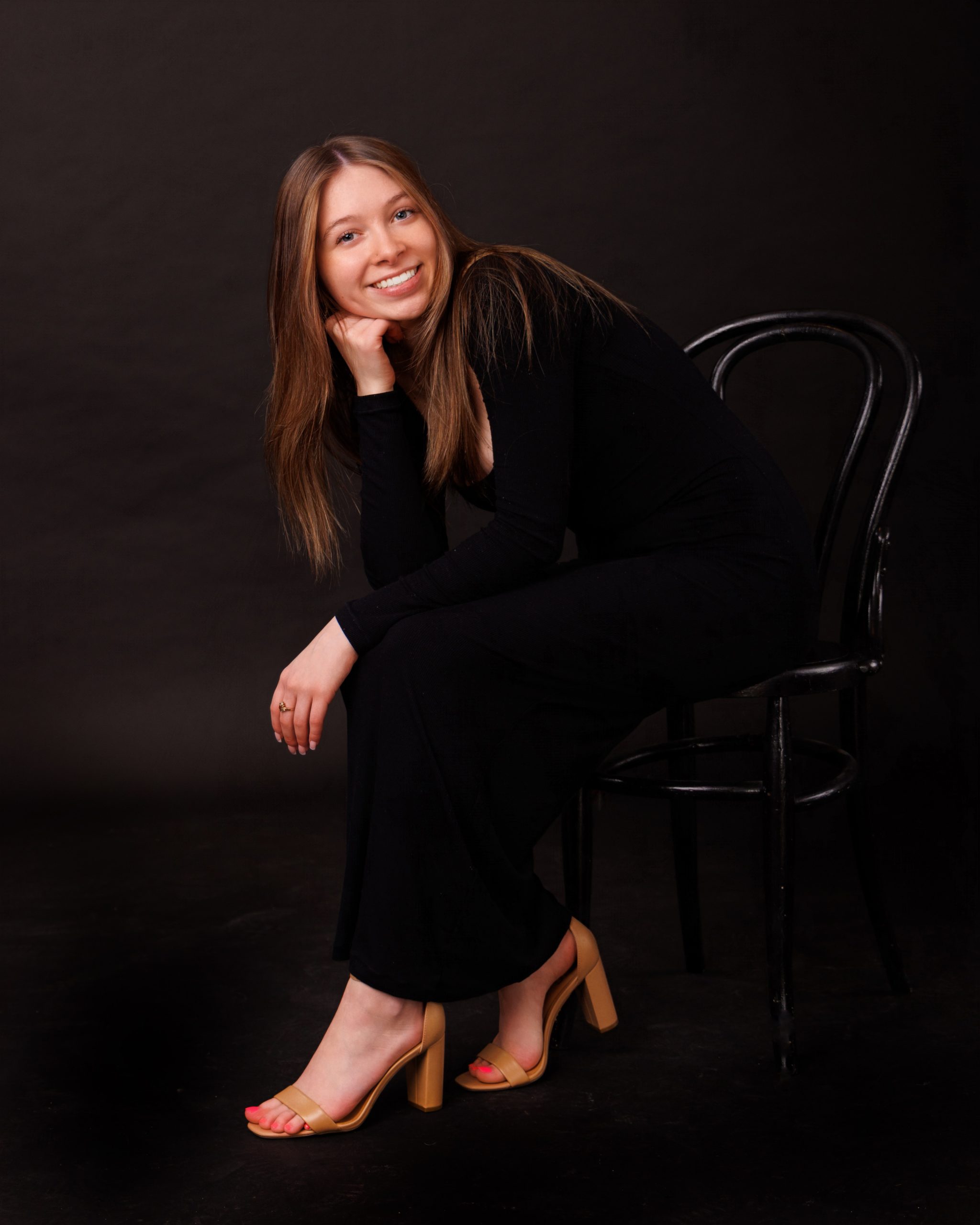 Hailey posing with graduation cap in floral dress during Downriver senior photo shoot