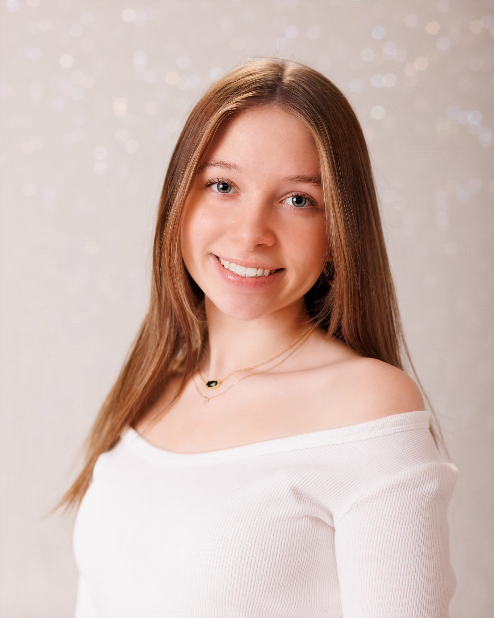 Hailey posing with graduation cap in floral dress during Downriver senior photo shoot