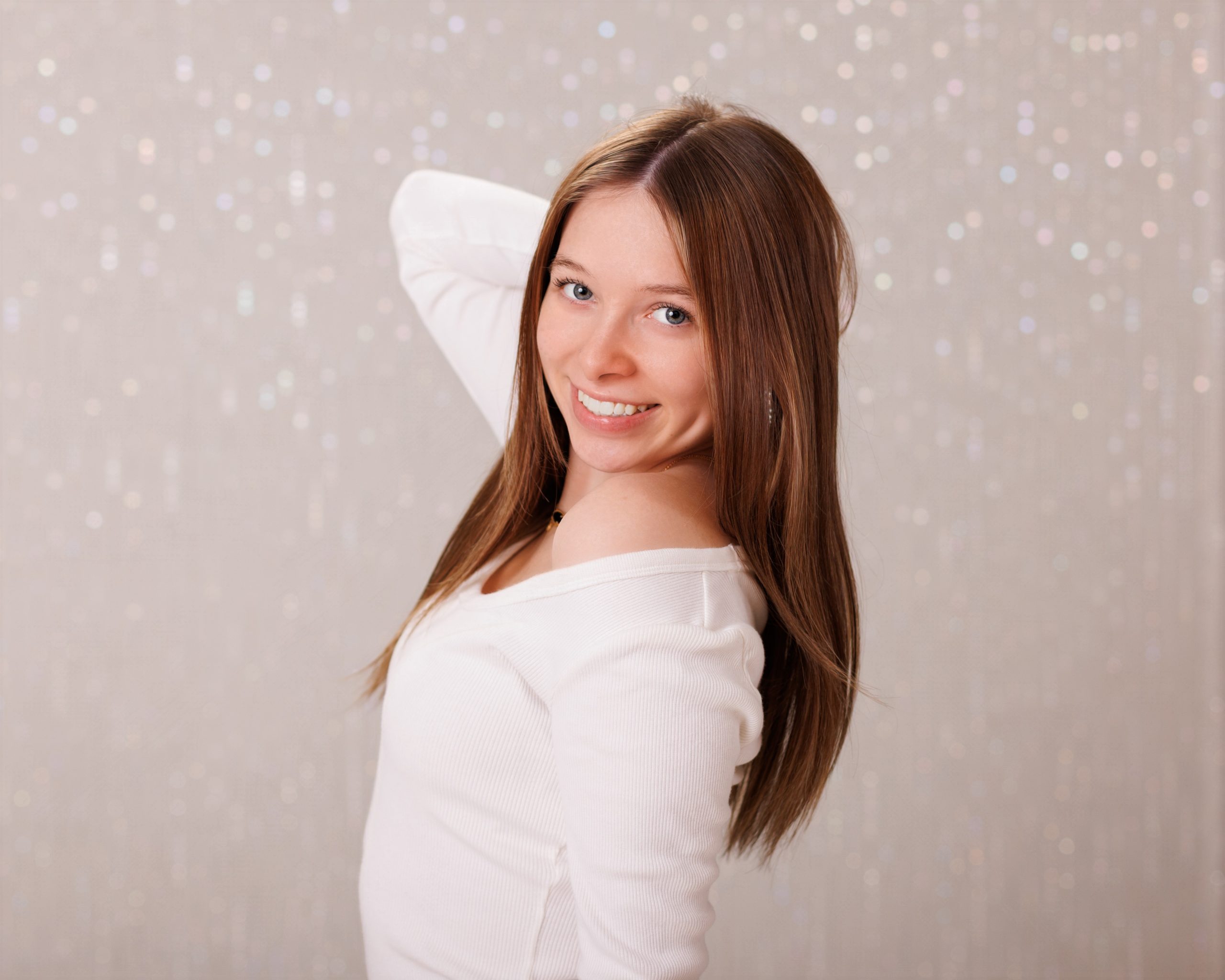 Hailey posing with graduation cap in floral dress during Downriver senior photo shoot