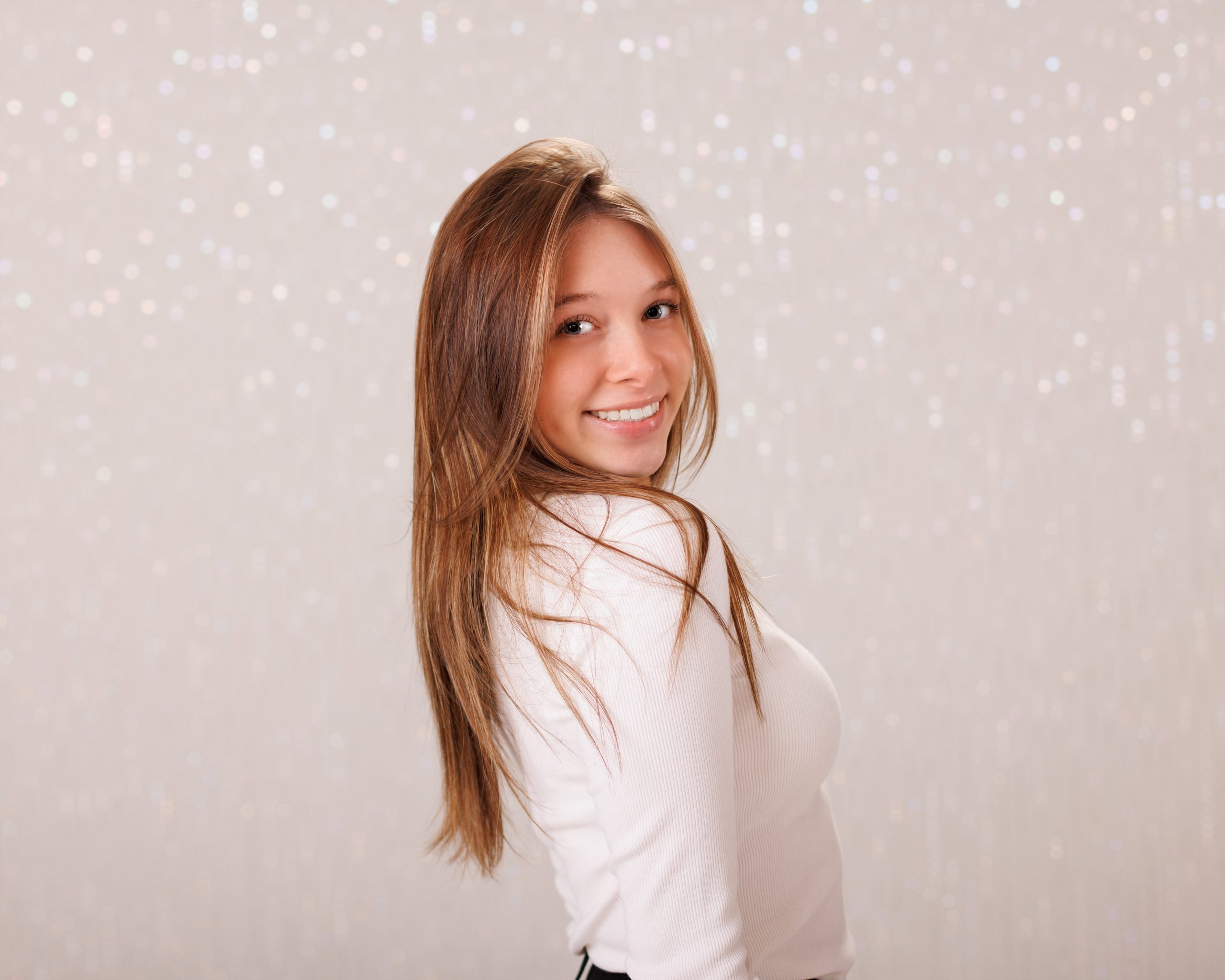 Hailey posing with graduation cap in floral dress during Downriver senior photo shoot