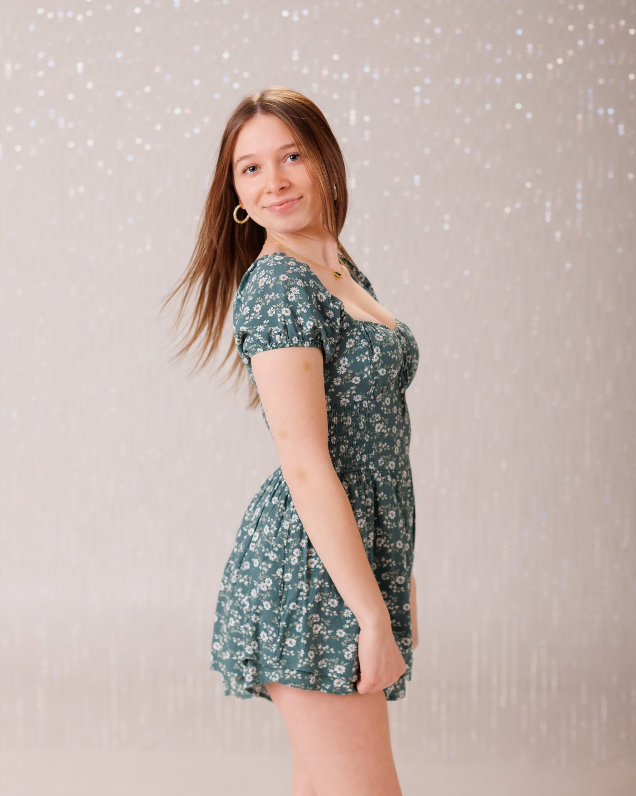 Hailey posing with graduation cap in floral dress during Downriver senior photo shoot