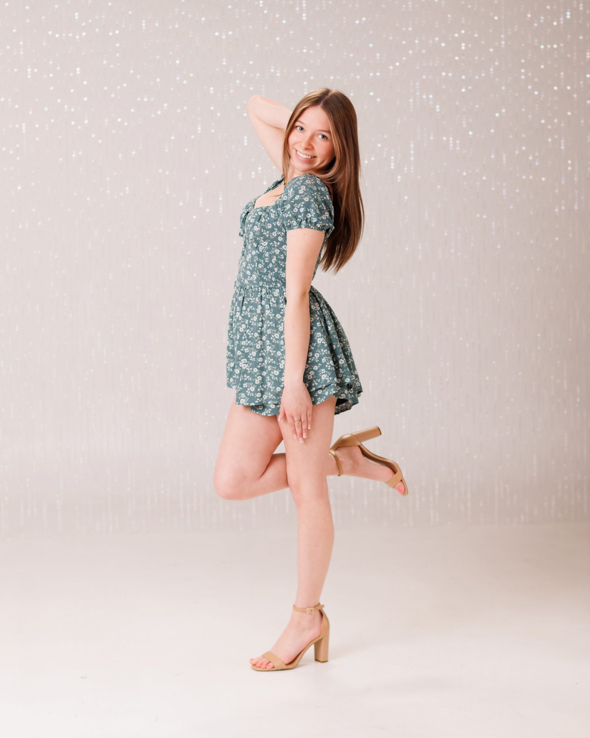 Hailey posing with graduation cap in floral dress during Downriver senior photo shoot