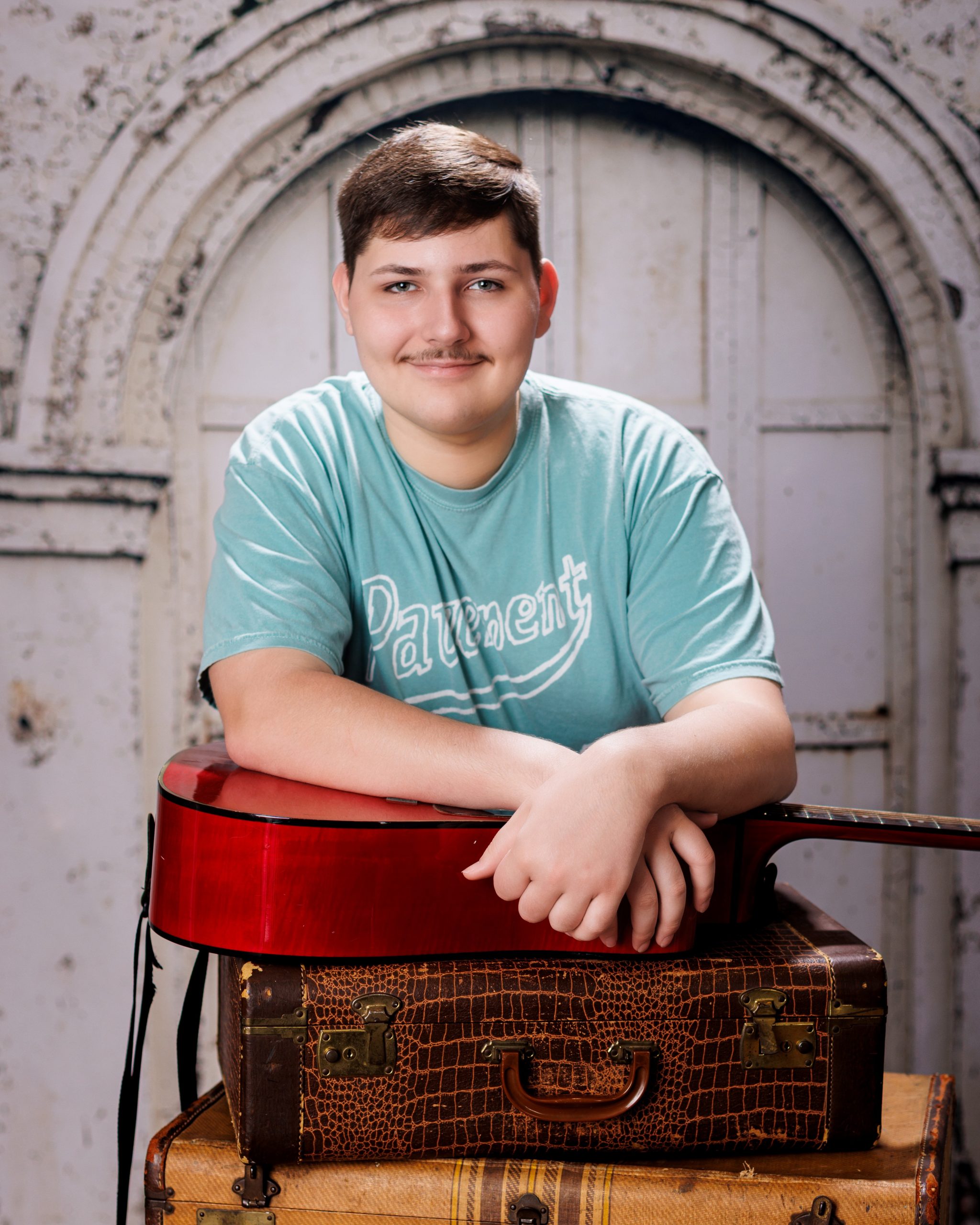 Tobias drumming professionally in formal attire during Dearborn senior photography session
