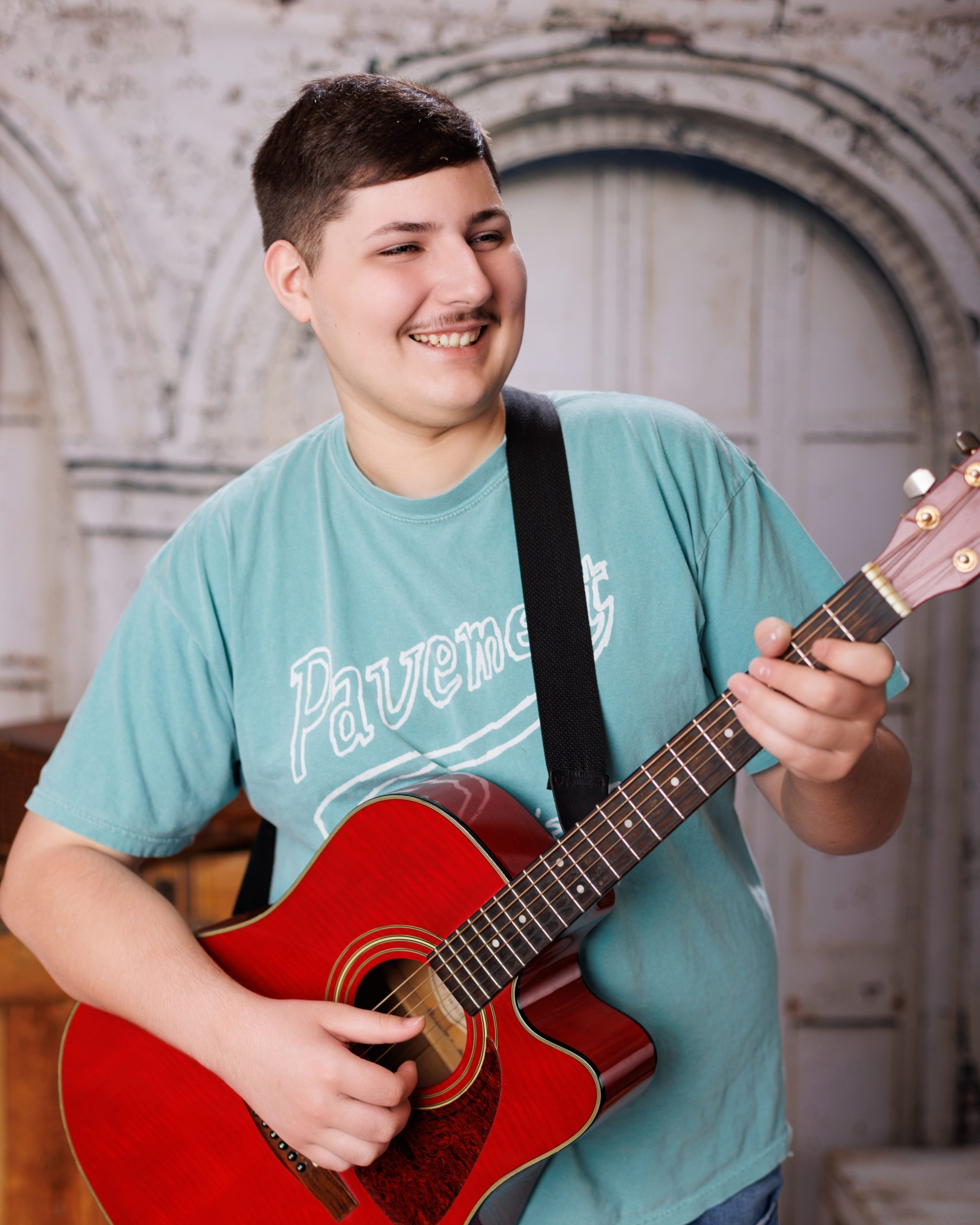 Tobias drumming professionally in formal attire during Dearborn senior photography session