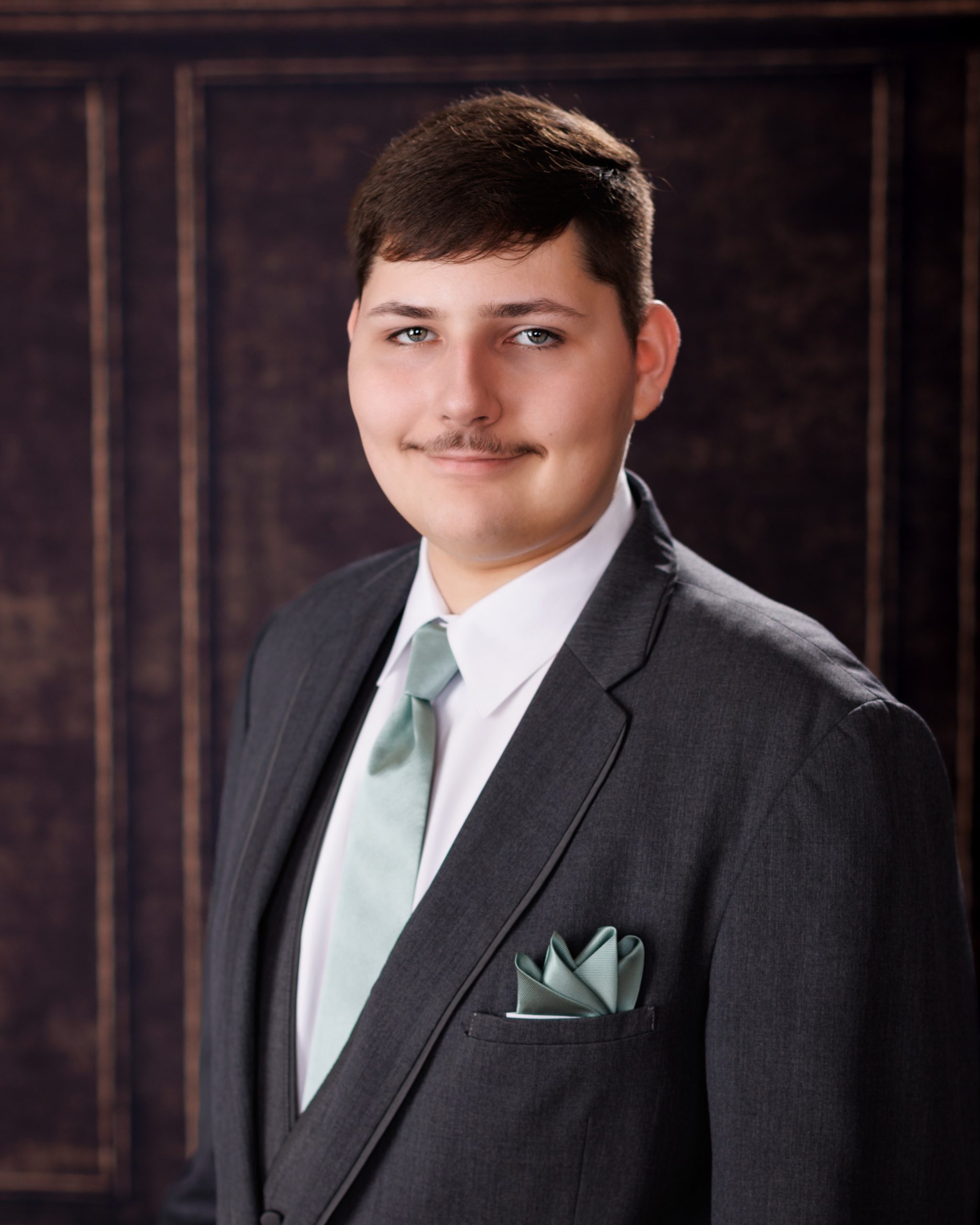 Tobias drumming professionally in formal attire during Dearborn senior photography session
